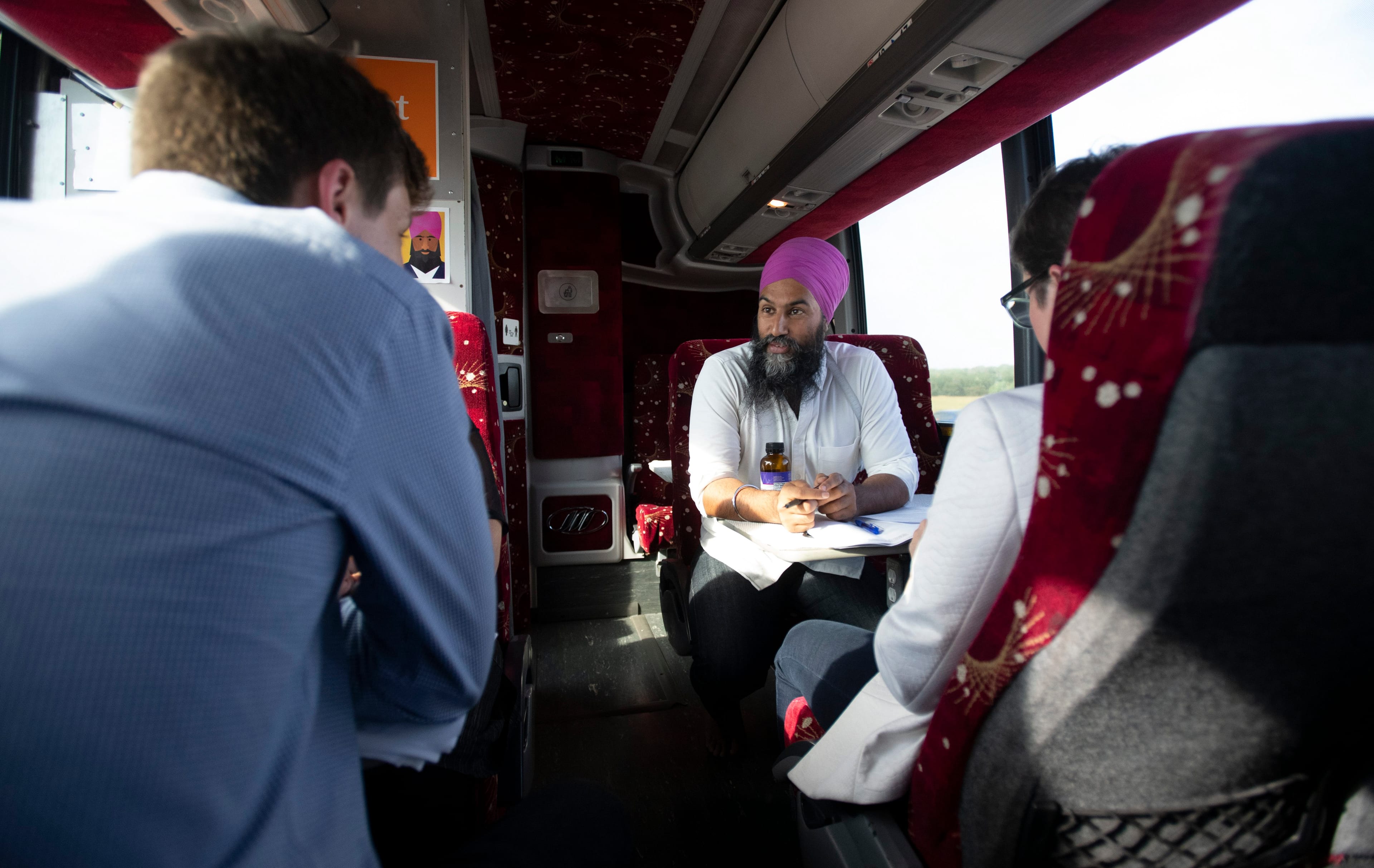 Singh, with staffers on his campaign bus, 
made his way across Ontario in September (Adrian Wyld/CP)