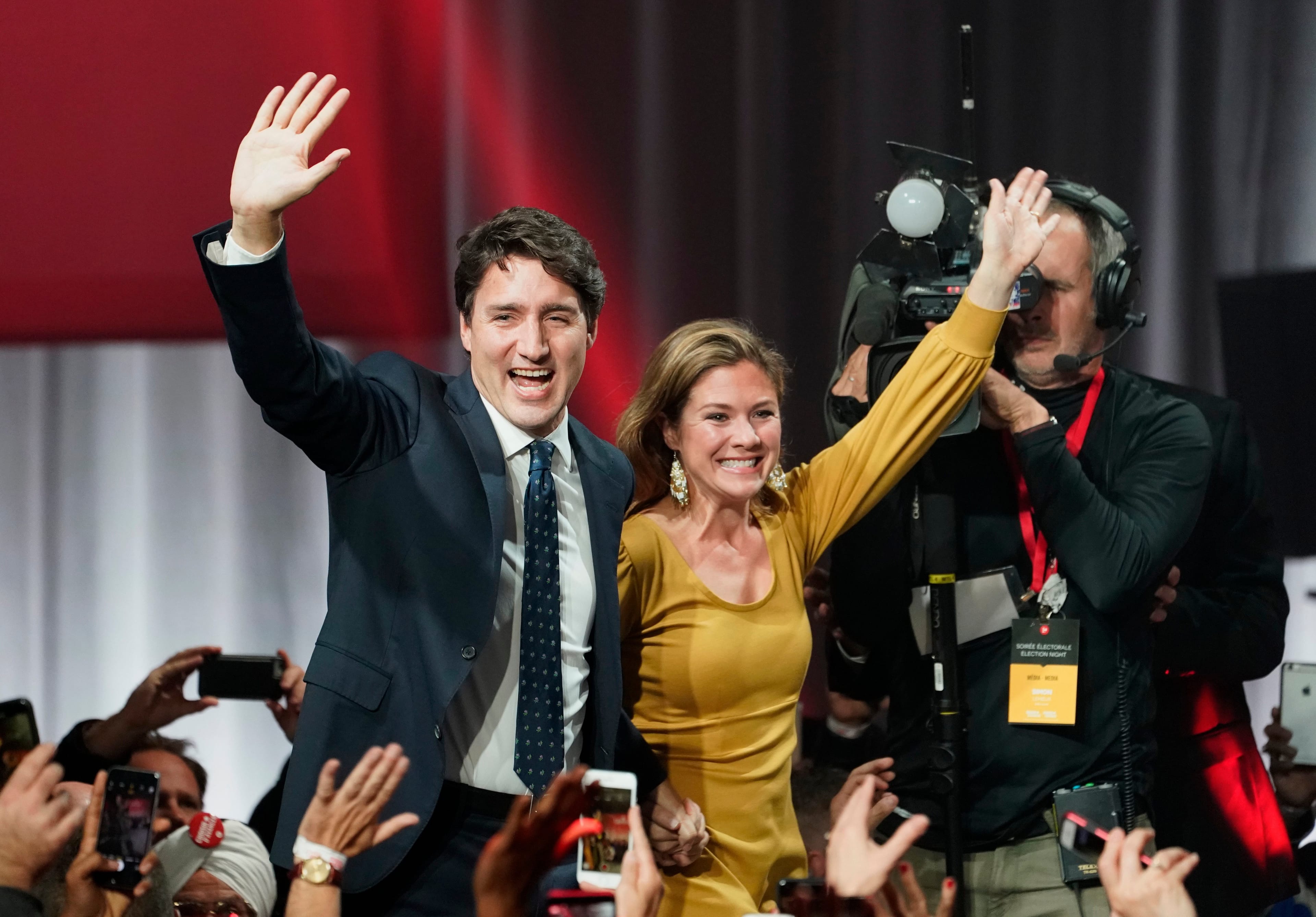 Liberal leader Justin Trudeau and wife Sophie Gregoire Trudeau wave as they go on stage at Liberal election headquarters in Montreal, Monday, Oct. 21, 2019. (Paul Chiasson/CP)