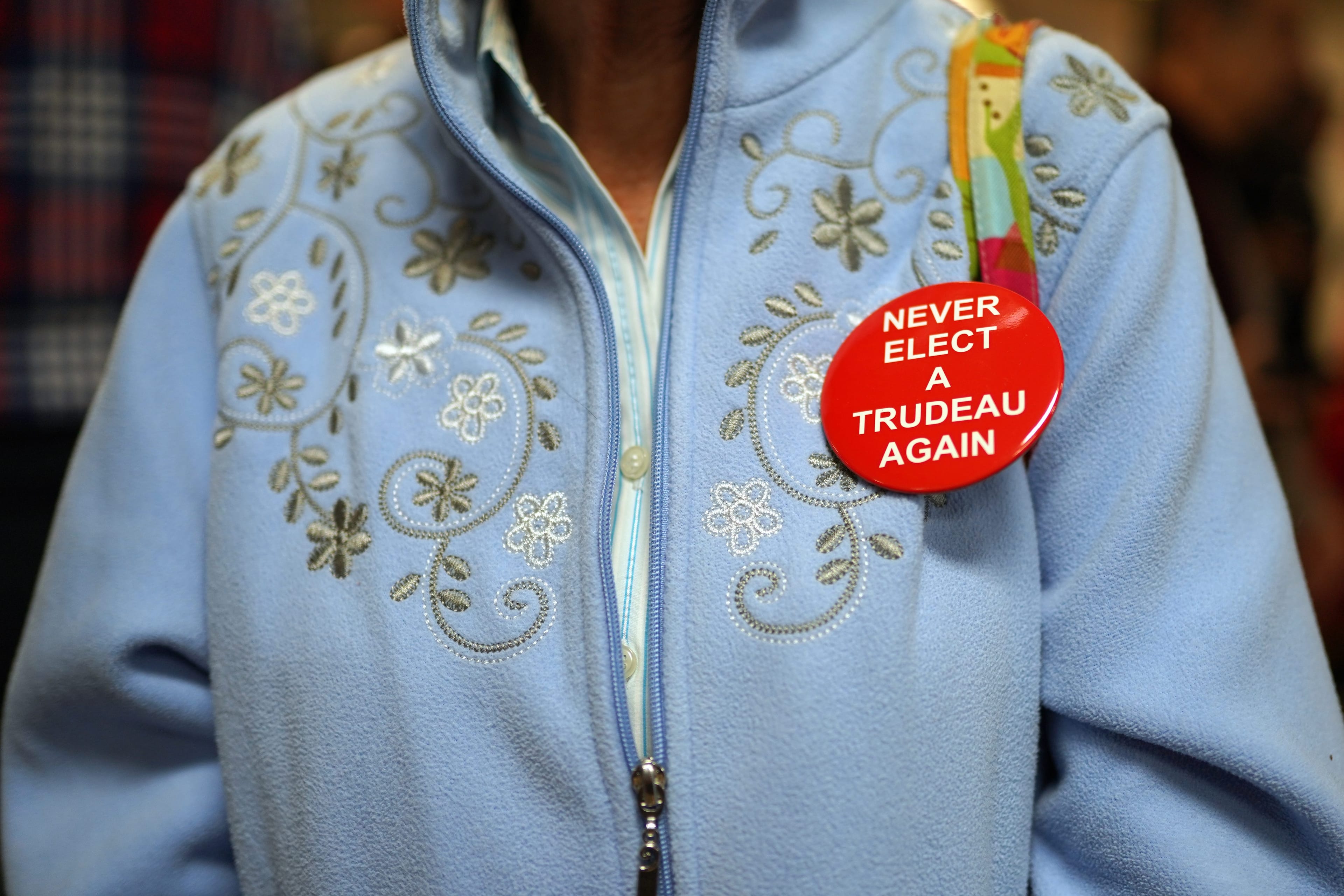 A Conservative supporter wears a button reading 'Never Elect A Trudeau Again' as Alberta Premier Jason Kenney campaigns with Conservative candidate Brian St. Louis in Ottawa on Friday, October 4, 2019. (Chris Wattie/CP)