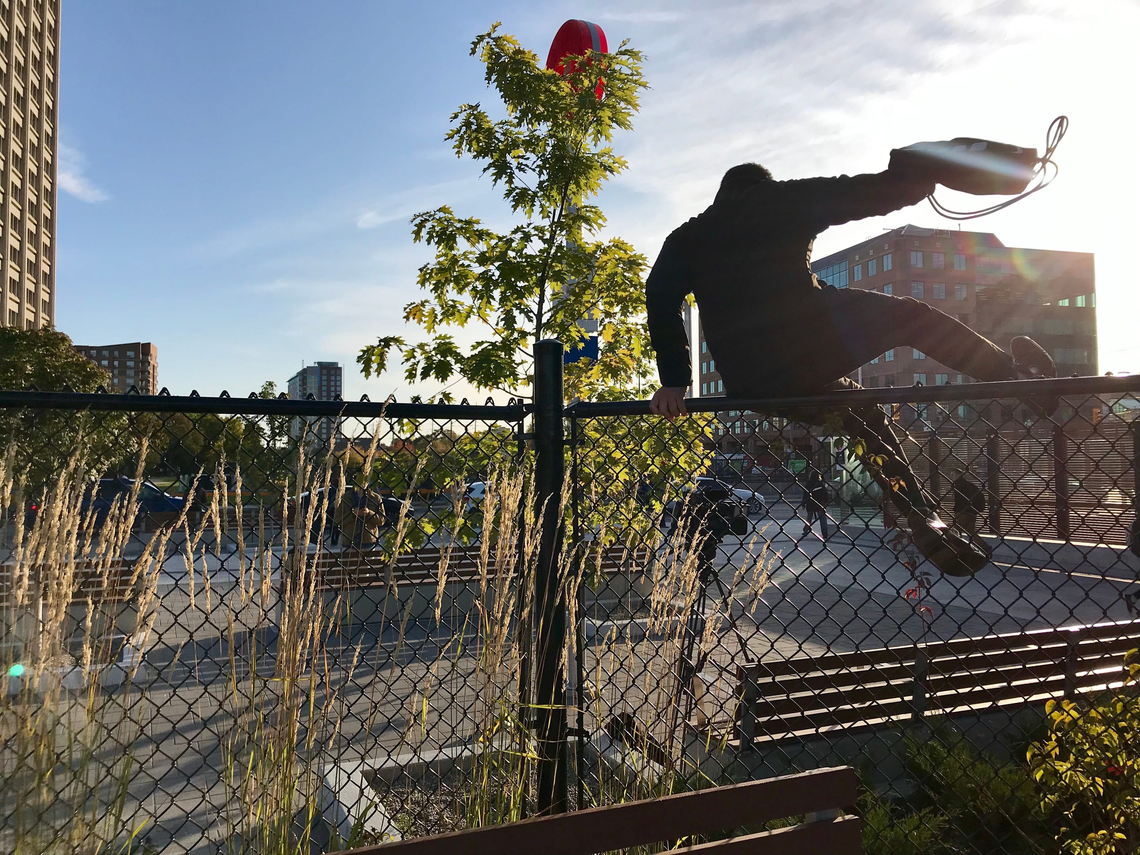 A commuter leaps the fence at Tunney’s Pasture station (Shannon Proudfoot)