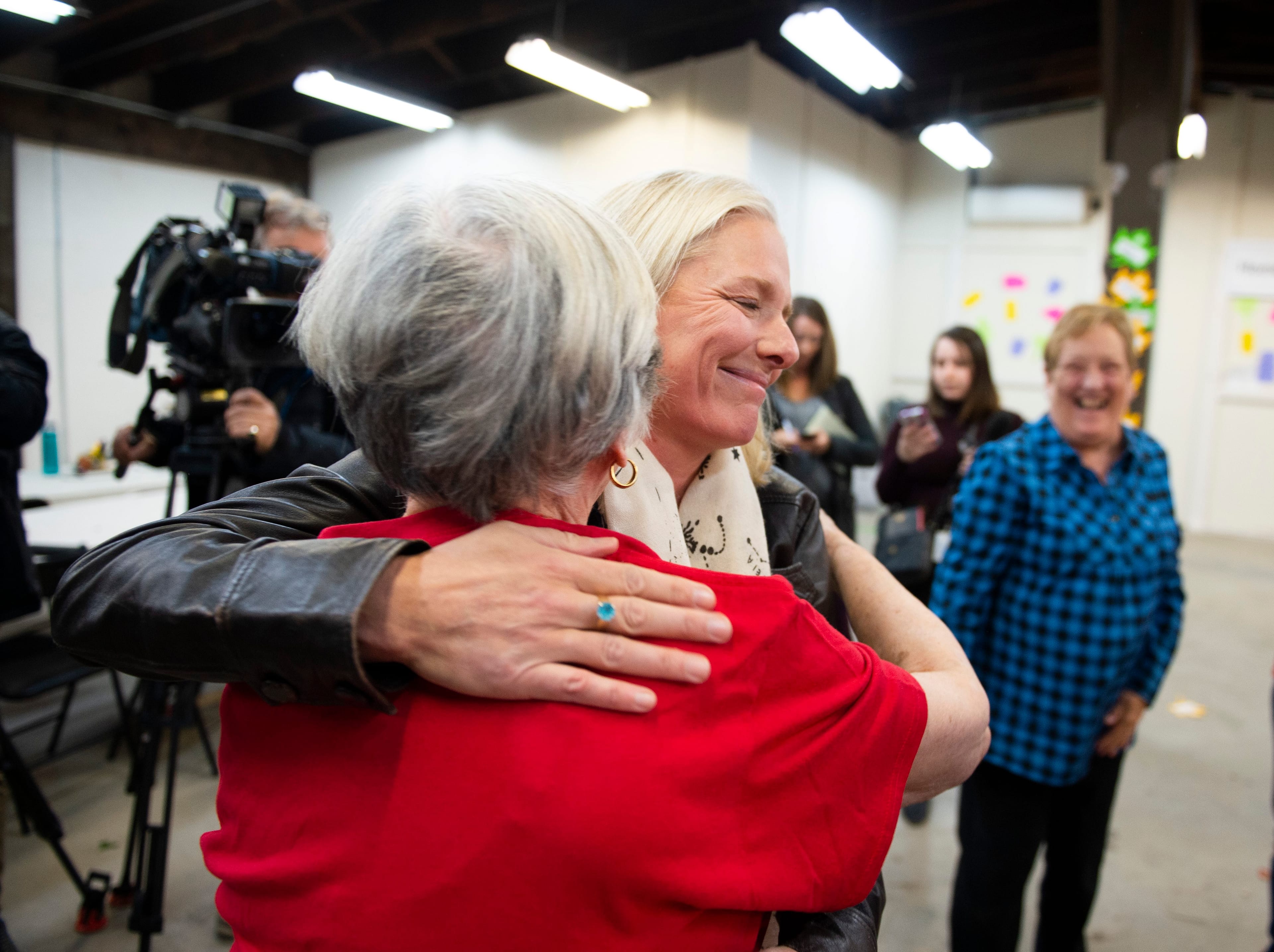 McKenna hugs a member of her team after speaking to reporters about a misogynistic slur spray painted on her constituency office in Ottawa, Oct. 24, 2019 (THE CANADIAN PRESS/Justin Tang)