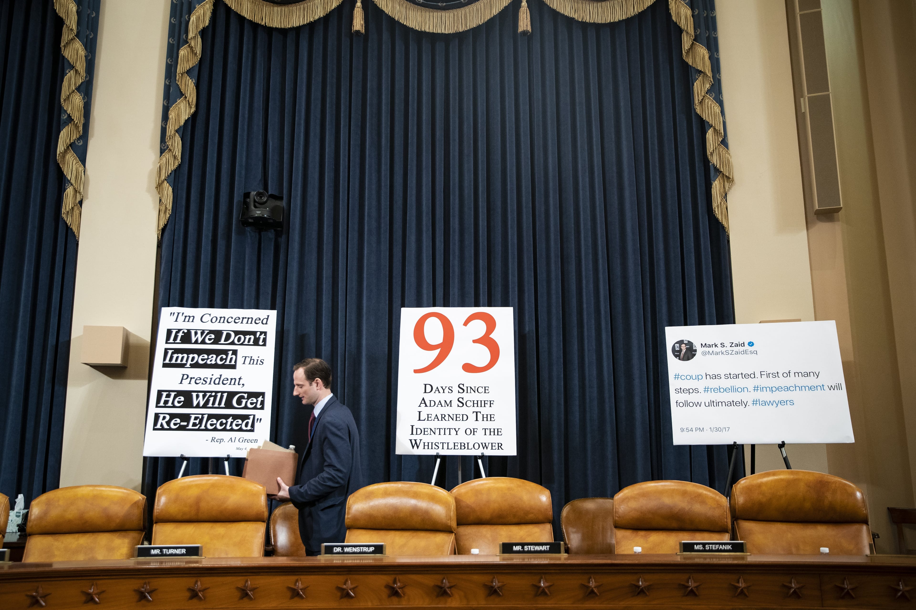Signs are displayed before a House Intelligence Committee impeachment inquiry hearing in Washington, D.C., on Nov. 13. (Al Drago/Bloomberg via Getty Images)
