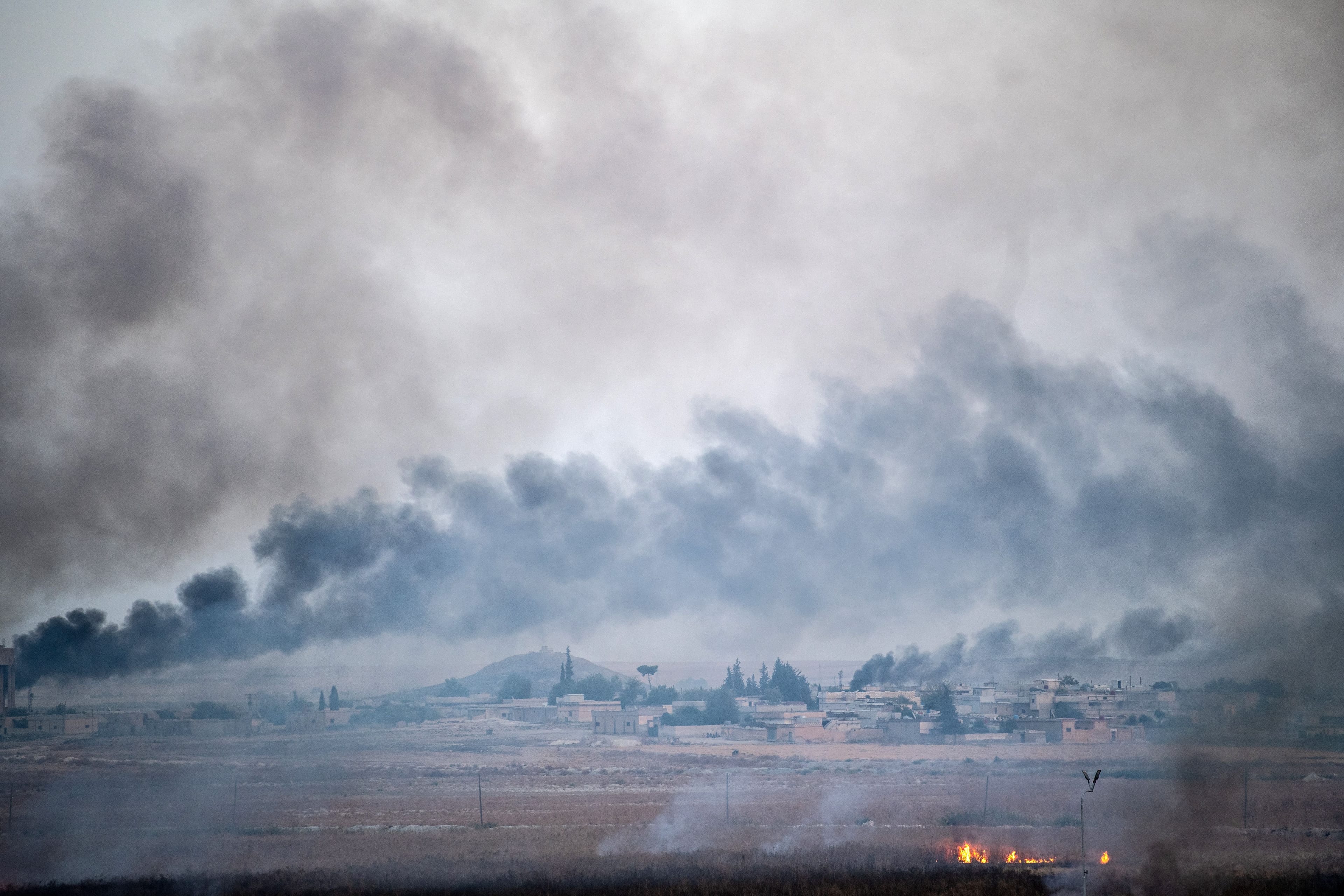 Smoke rises from the Syrian town of Tal Abyad, on Oct. 10, 2019, on the second day of Turkey's military operation against Kurdish forces (BULENT KILIC/AFP via Getty Images)