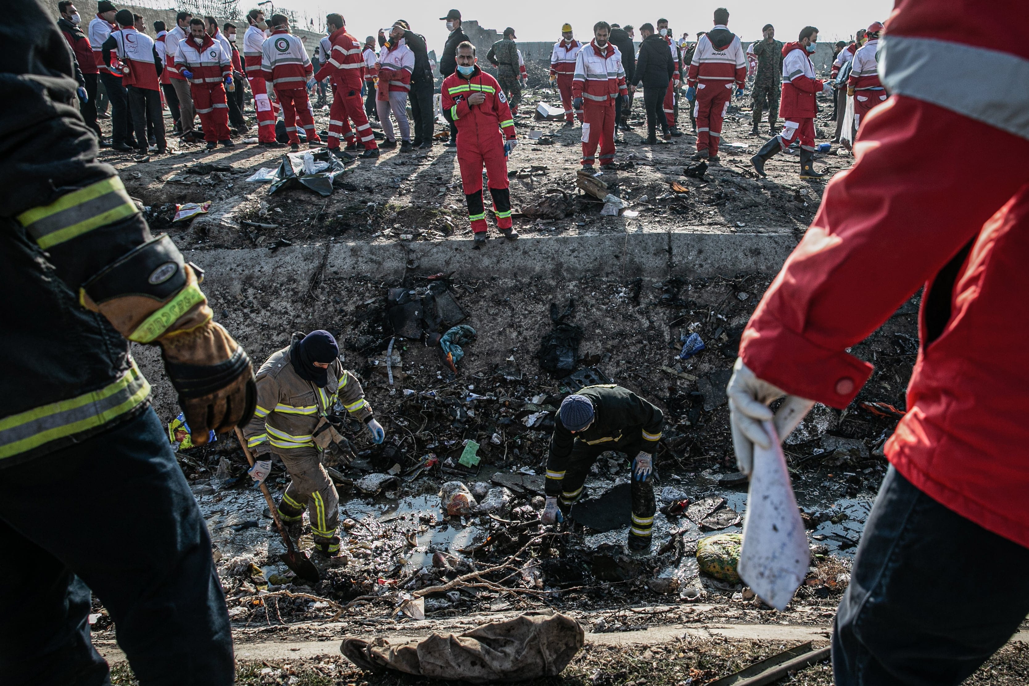 Rescue workers search the scene where the Ukrainian airplane crashed on Wednesday shortly after takeoff from Tehran airport (Foad Ashtari/Getty Images)