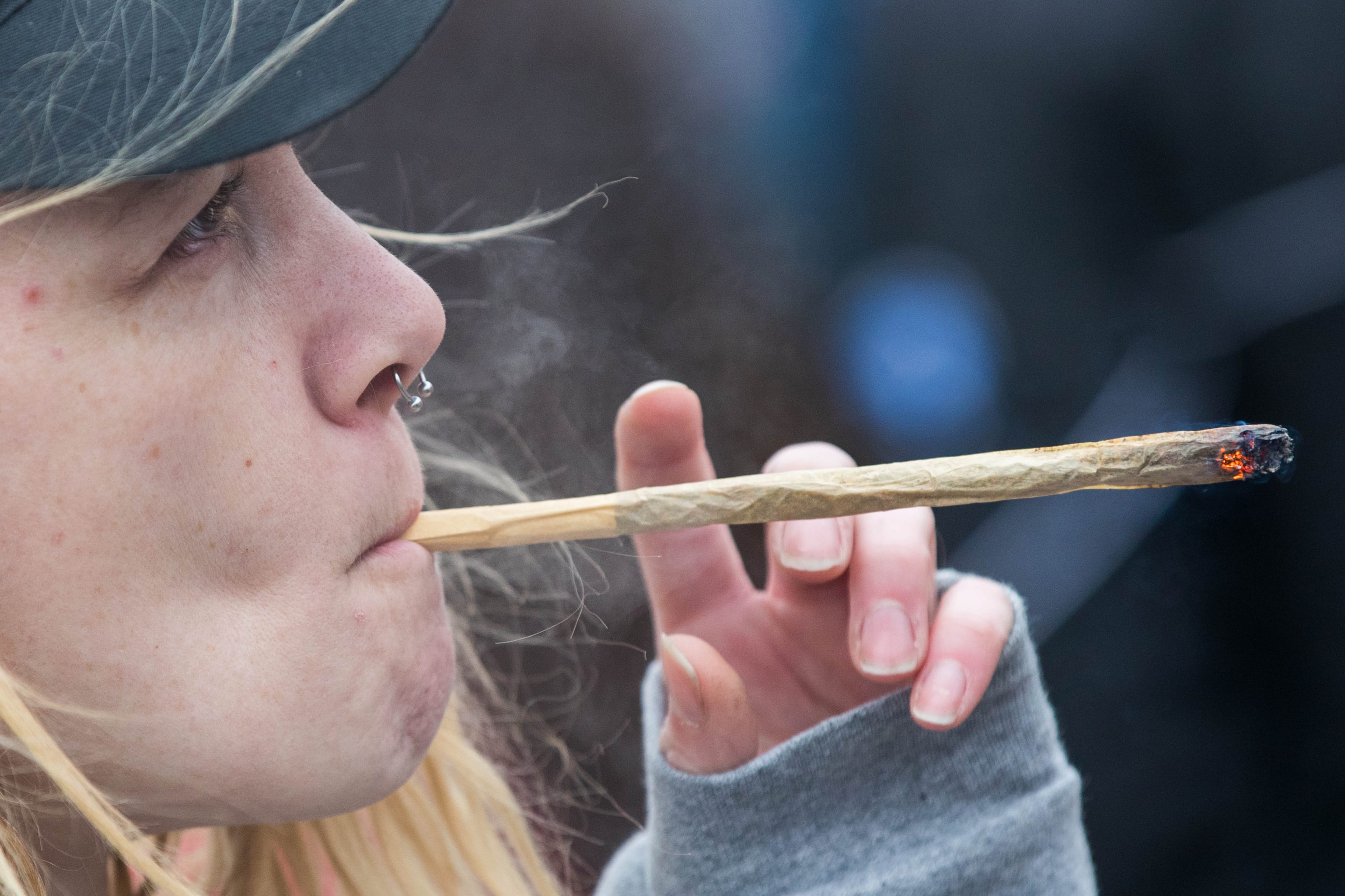 A woman smokes marijuana during the annual 4/20 rally on Parliament Hill in Ottawa on April 20, 2019. (Lars Hagberg/AFP/Getty Images)