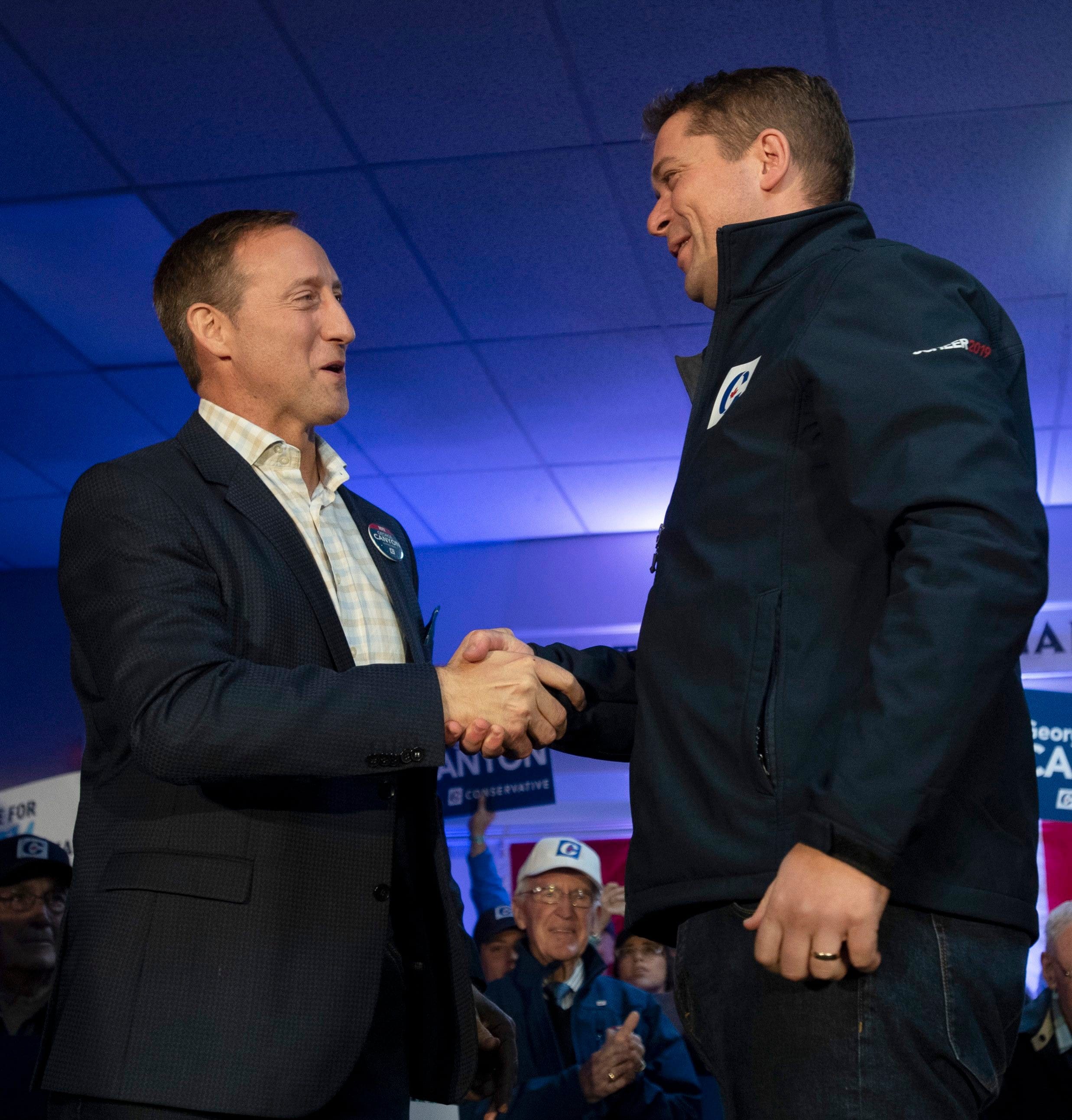 Conservative leader Andrew Scheer shakes hands with Peter MacKay during a campaign stop in Little Harbour, N.S., on Oct. 17, 2019 (CP/Adrian Wyld)