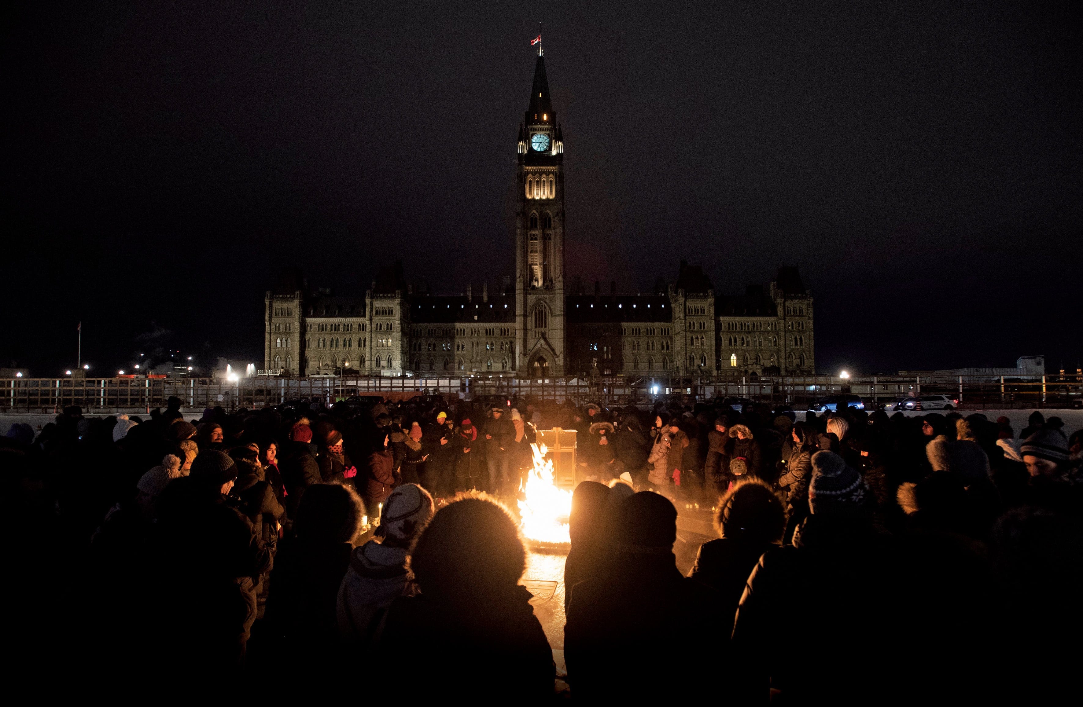Several hundred people gather around the Centennial flame in Ottawa for a vigil to remember those killed on Ukraine International Airlines Flight 752. (Adrian Wyld/CP)
