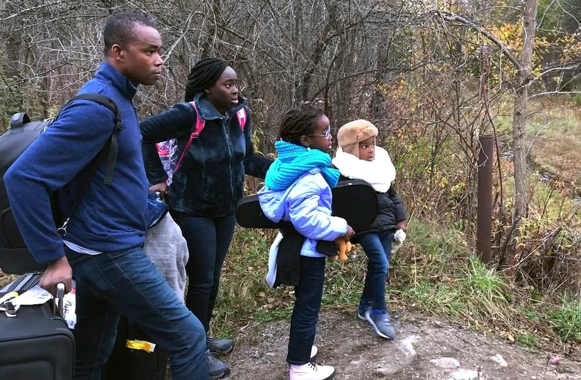 A Nigerian family crosses into Canada last November at Roxham Road, near Saint-Bernard-de-Lacolle, Que. Trump's expanded travel ban may increase asylum seekers from Nigeria, but skilled workers coming through conventional channels could become the bigger surge. (Wilson Ring/AP)