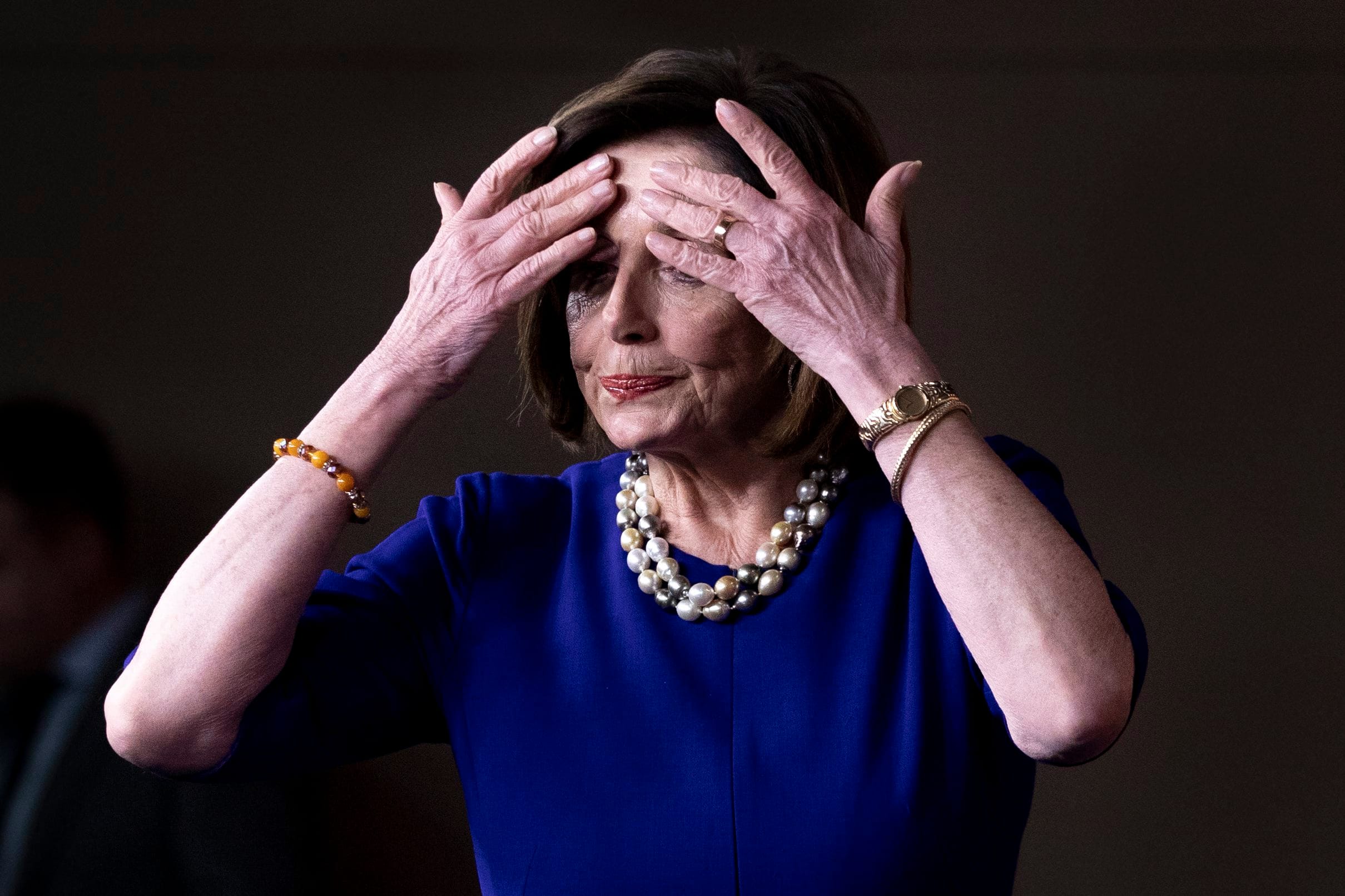 Pelosi touches her hair as she arrives to hold a news conference Thursday in the U.S.Capitol (Michael Reynolds/ EPA via CP)
