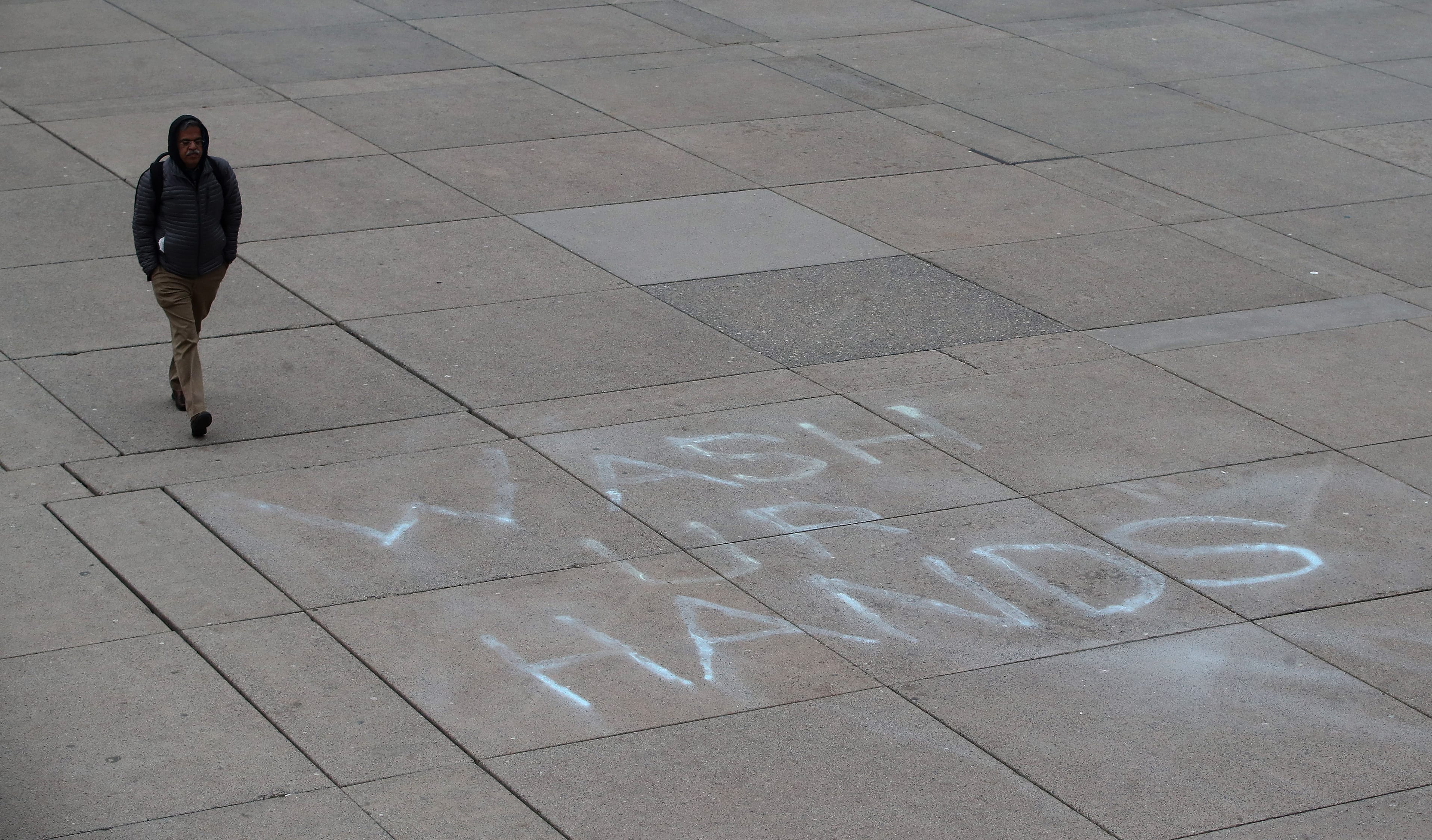 A person walks through  Nathan Phillips Square at Toronto City Hall on March 19, 2020 (Steve Russell/Toronto Star via Getty Images)