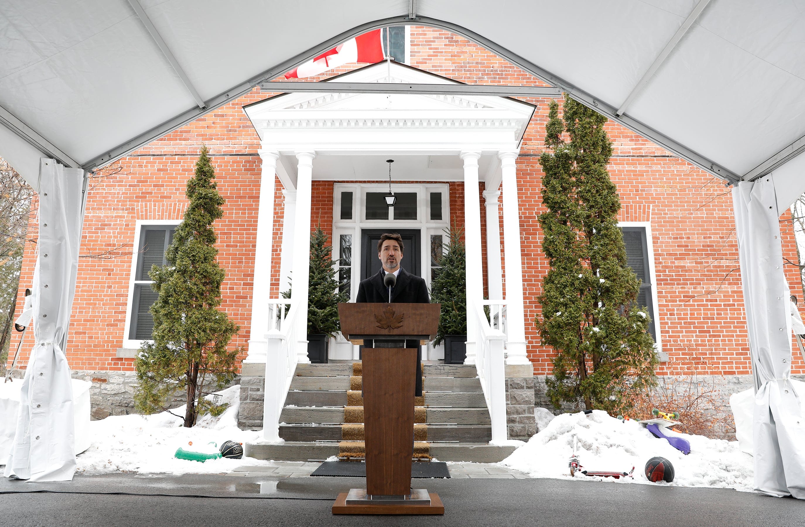 Trudeau takes questions outside Rideau Cottage, flanked by snowbanks where his kids left their toys. (Blair Gable/Reuters)