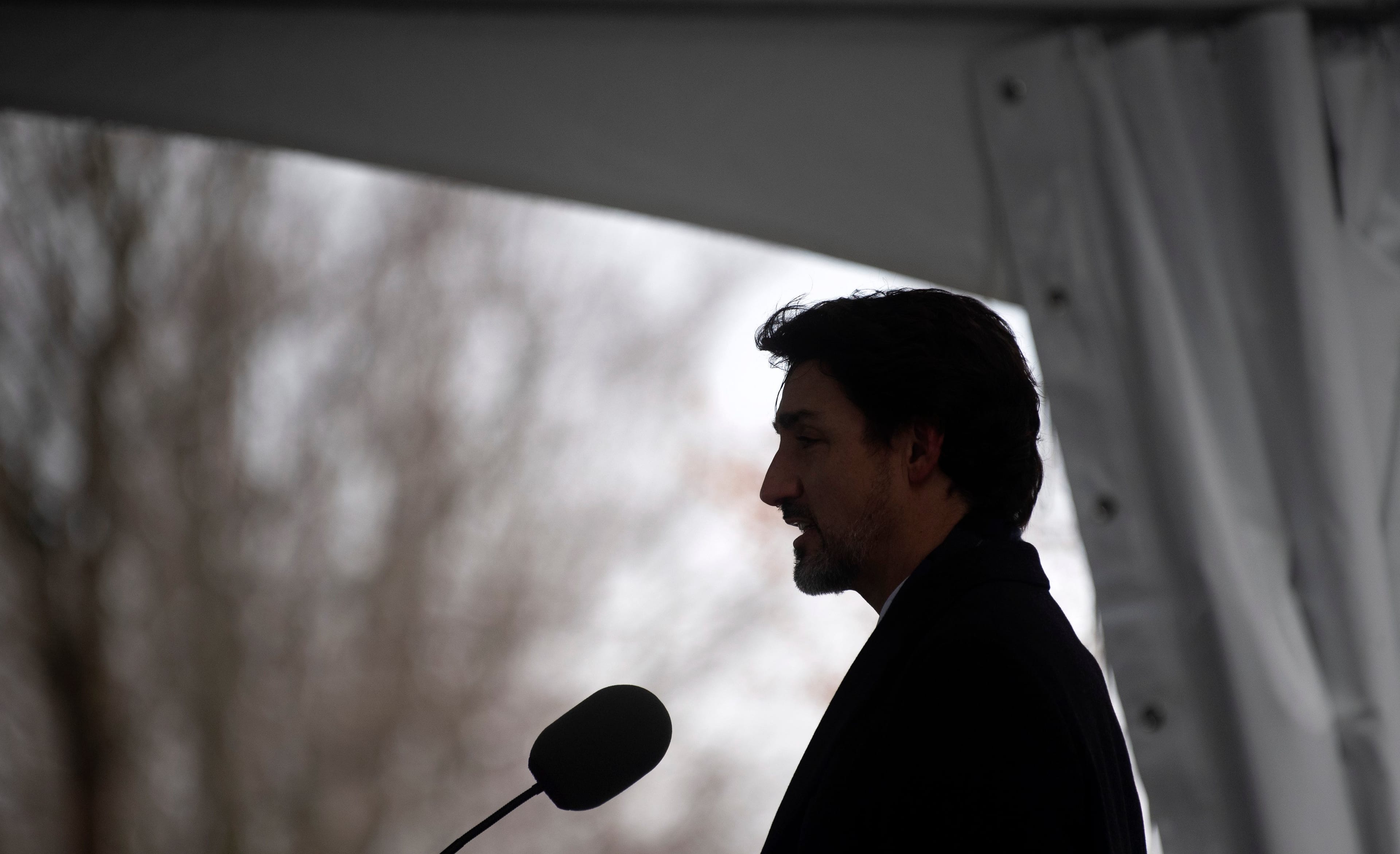 Prime Minister Justin Trudeau is silhouetted as he speaks to the media about Canada's response to the COVID-19 virus in Ottawa, Tuesday, March 17, 2020. THE CANADIAN PRESS/Adrian Wyld