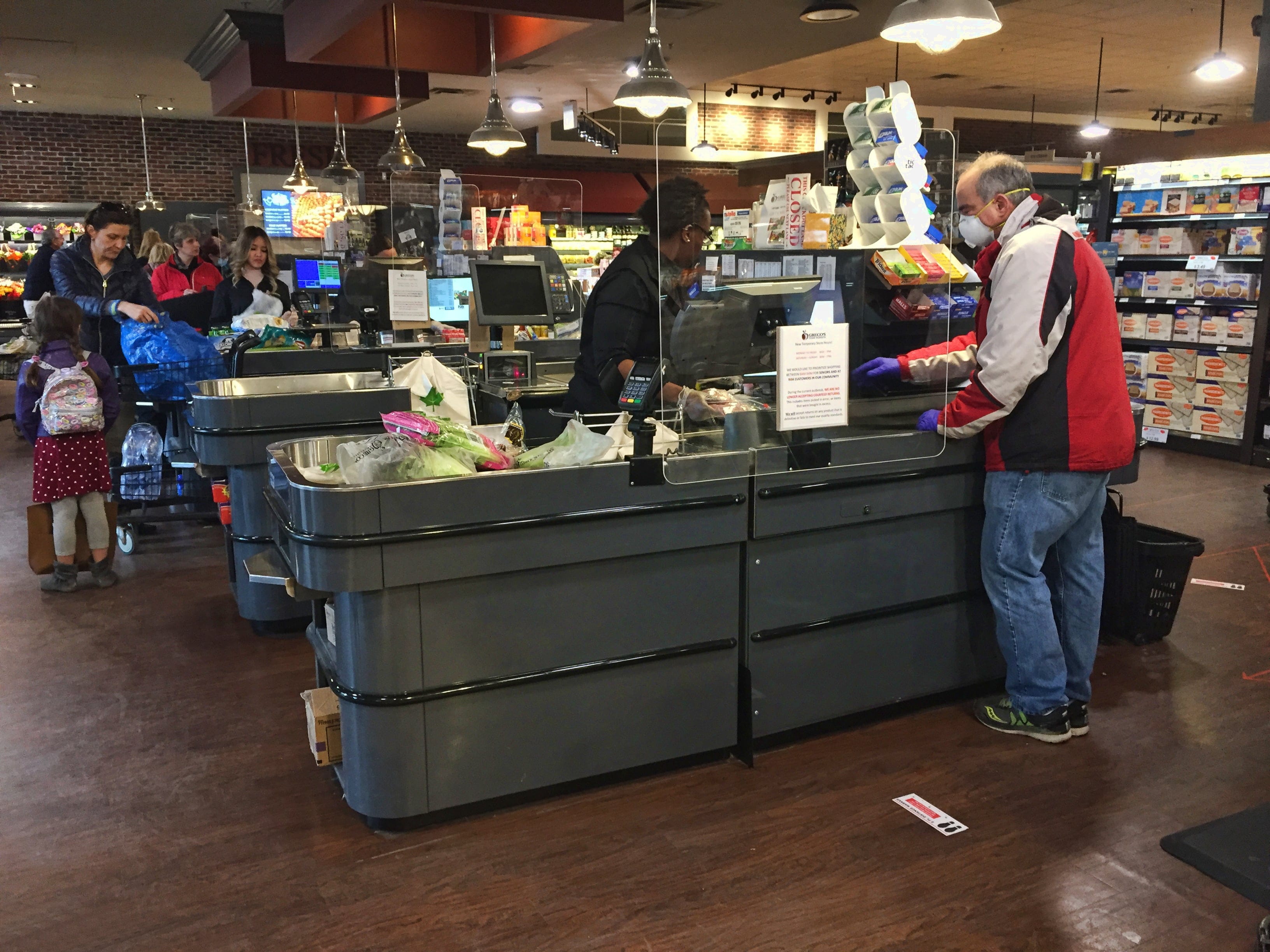 Cashiers behind newly installed plexiglass (acrylic) shields to protect them from the novel coronavirus (COVID-19) at a grocery store on April 03, 2020 in Toronto, Ontario, Canada. (Photo by Creative Touch Imaging Ltd./NurPhoto via Getty Images)