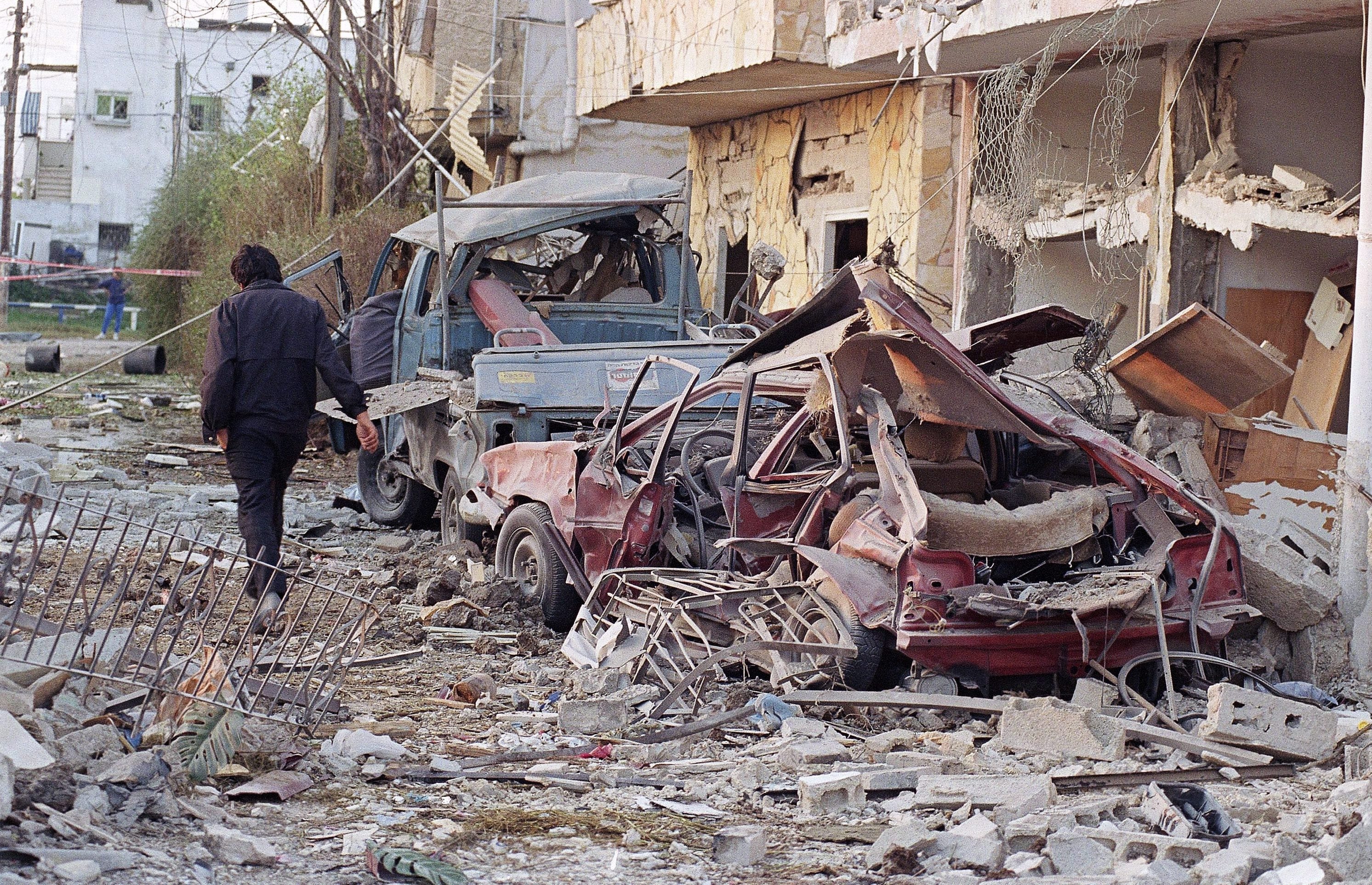 In this Jan. 18, 1991 file photo, a person walks through the debris in Tel Aviv after eight Iraqi scud missiles were fired at Israel. (John Gaps III/File/AP/CP)