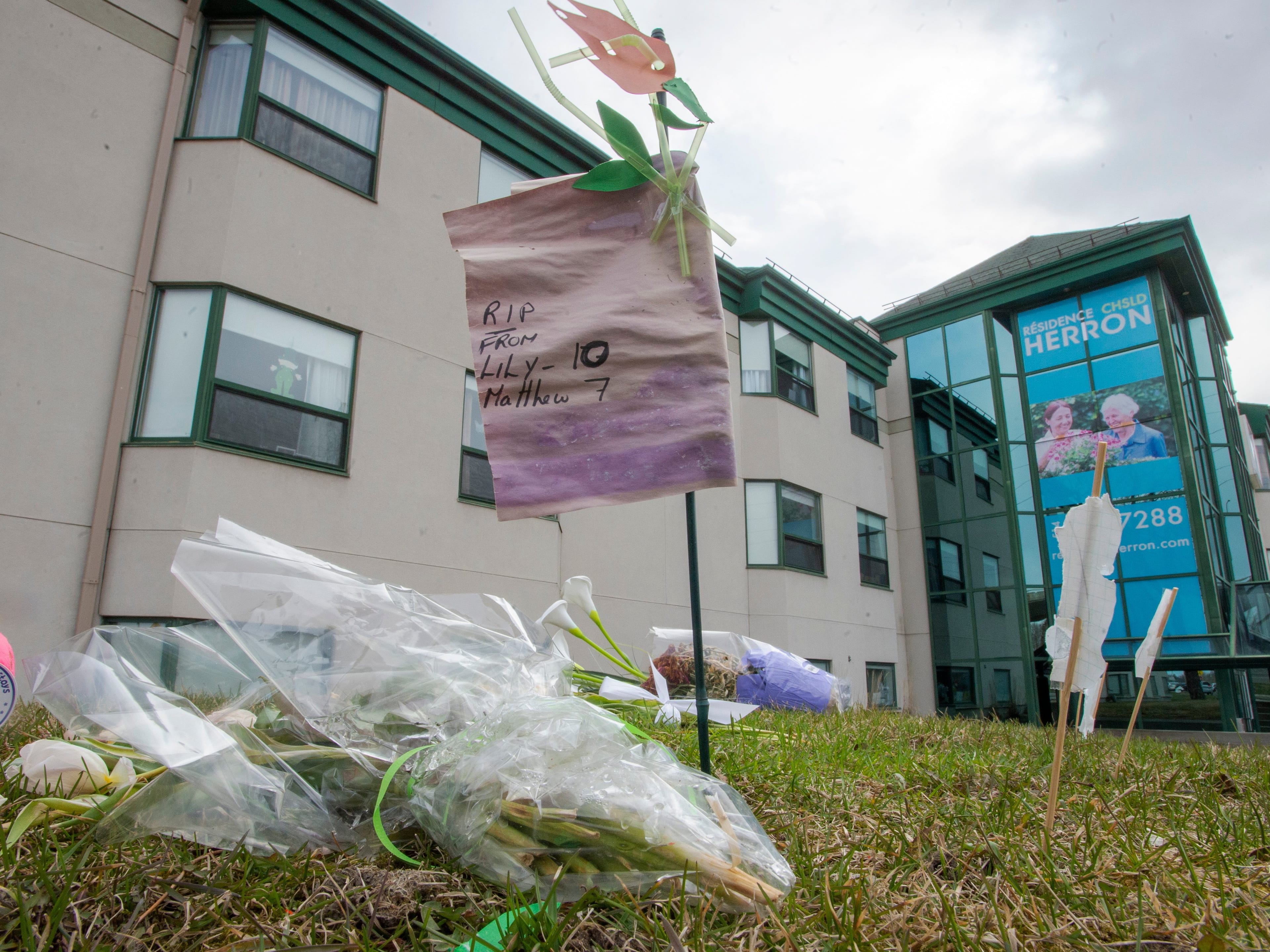 Flowers and notes for loved ones are seen at a makeshift memorial in front of the CHSLD Herron seniors residence Wednesday April 22, 2020 in Dorval, Que. (Ryan Remiorz/CP)