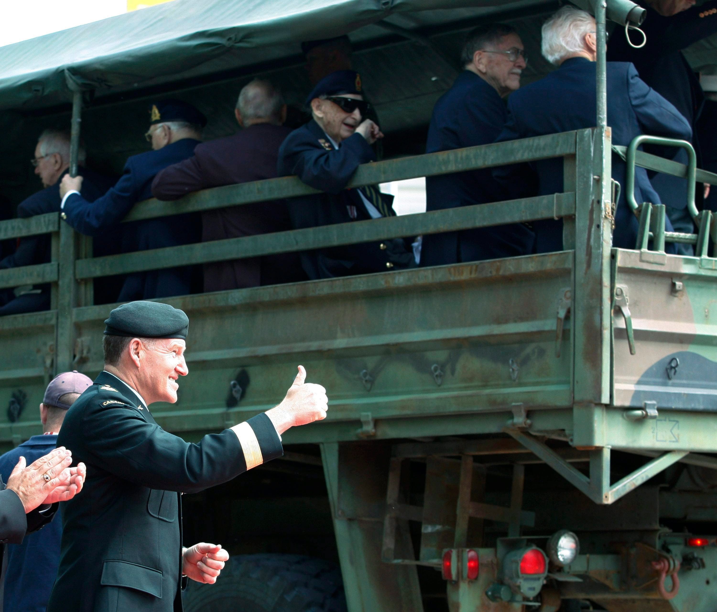 Chief of National Defence General Walter Natynczyk gives the thumbs up to veterans who arrive by military trucks in Ottawa on June 6, 2009 to take part in the 65th anniversary of D-Day (CP/Fred Chartrand)
