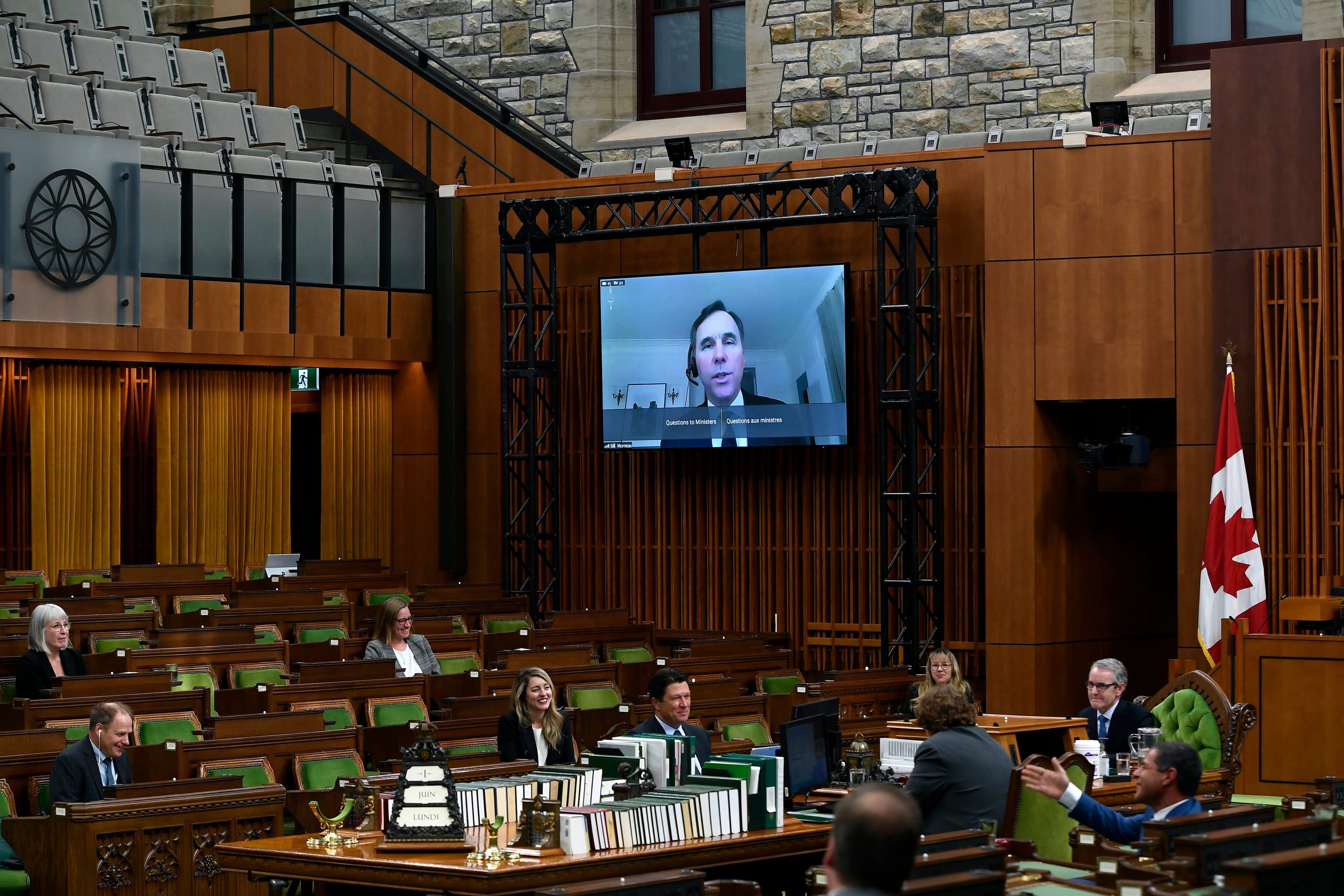 Minister of Finance Bill Morneau appears via video conference on a digital display at a meeting of the Special Committee on the COVID-19 Pandemic in the House of Commons on Parliament Hill in Ottawa, on Monday, June 1, 2020. (ustin Tang/CP)