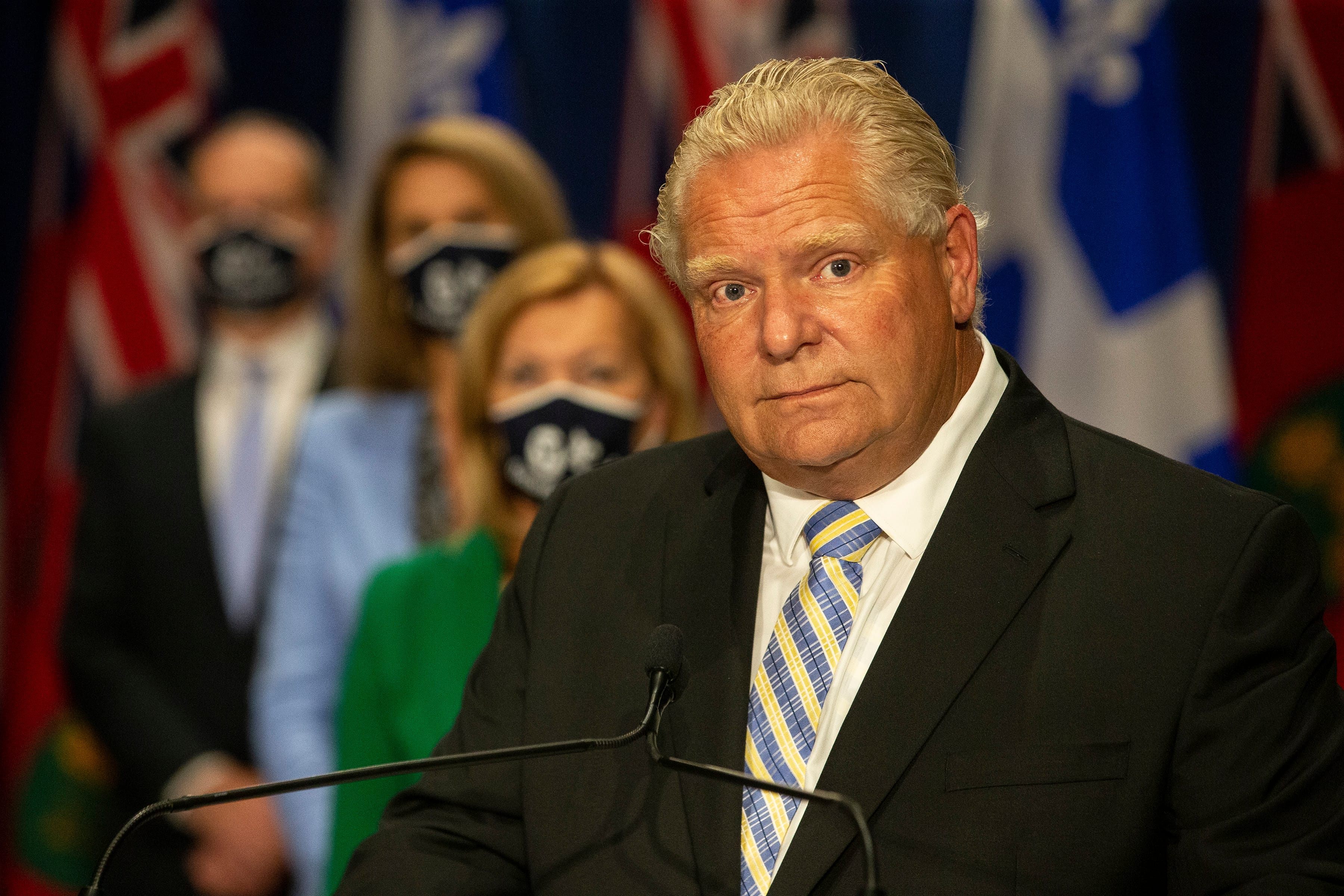 Ontario Premier Doug Ford, right, stands in front of a selection of his cabinet ministers during a joint press conference with Quebec Premier Francois Legault at the Ontario-Quebec Summit, in Toronto on Wednesday, September 9, 2020. THE CANADIAN PRESS/Chris Young