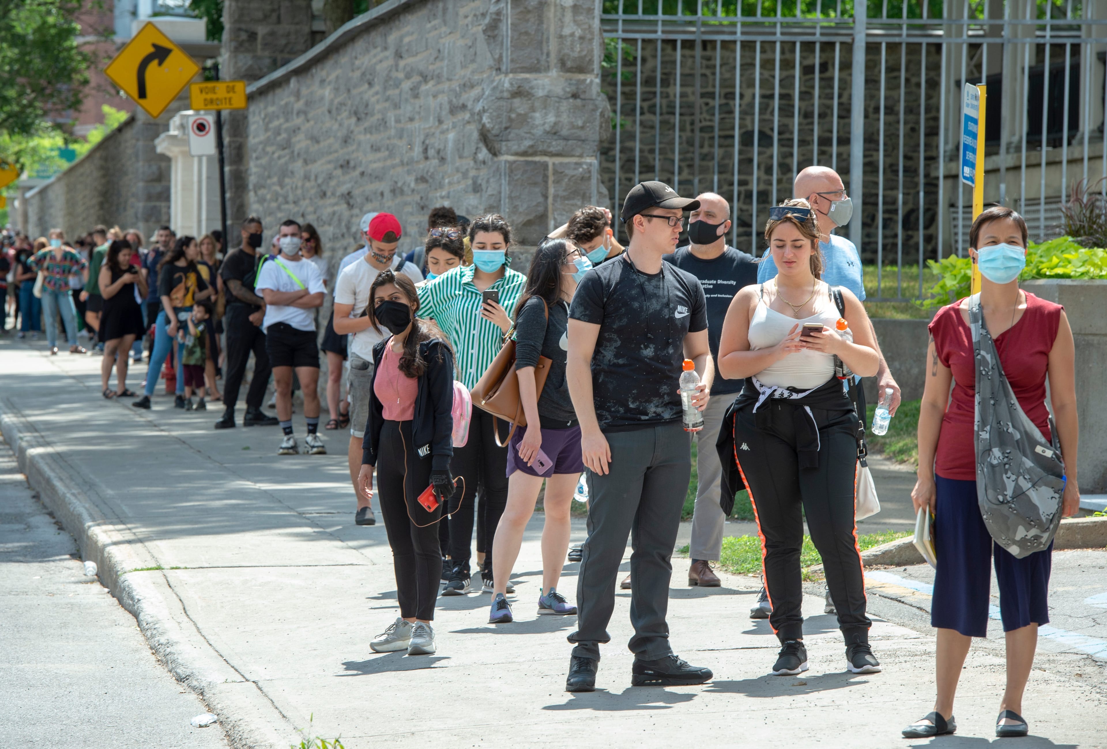 Hundreds of people lineup at the COVID-19 testing clinic Tuesday, July 14, 2020 in Montreal. (Ryan Remiorz/CP)