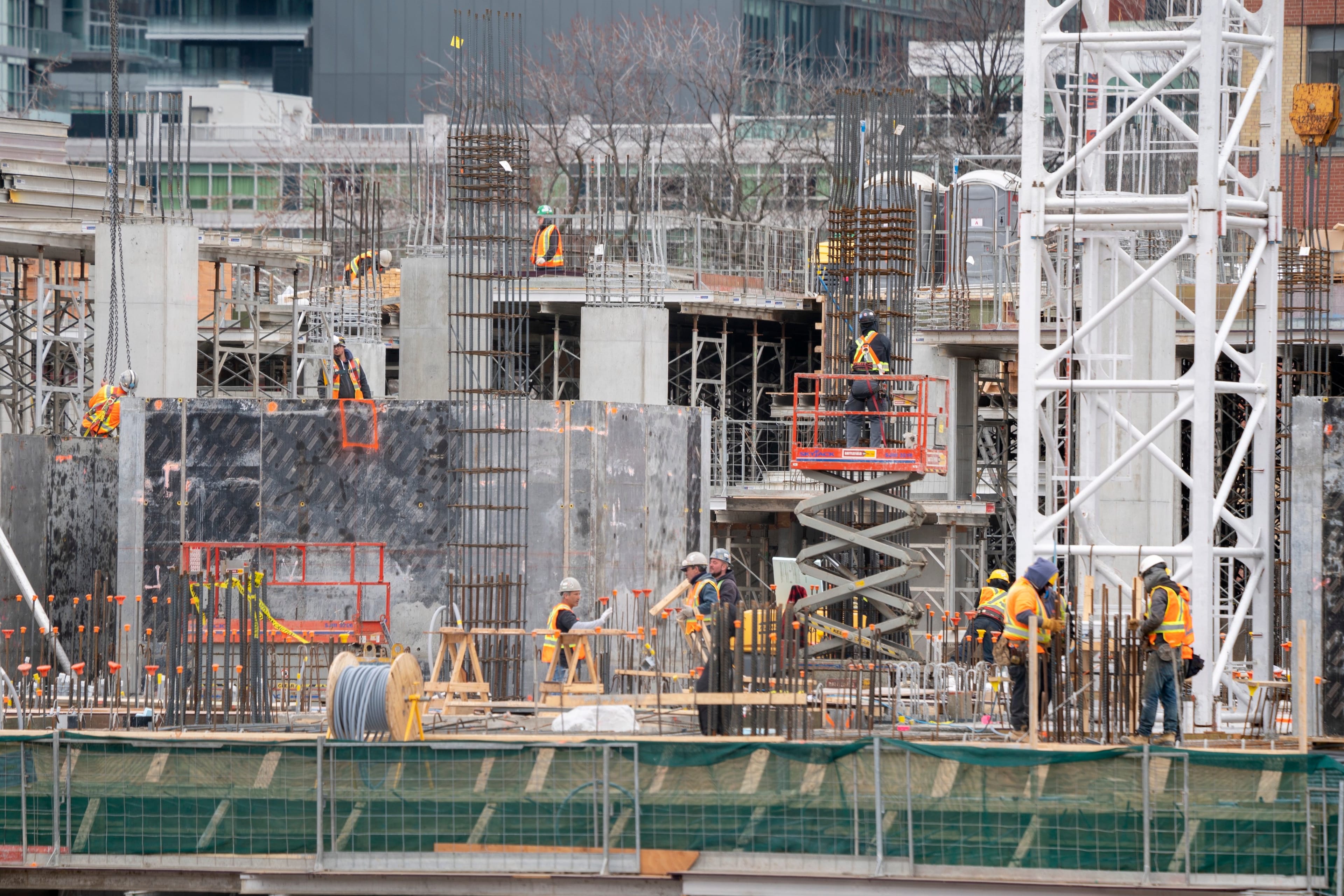 Workers are shown at a construction site in Toronto on Wednesday, March 18, 2020. THE CANADIAN PRESS/Frank Gunn