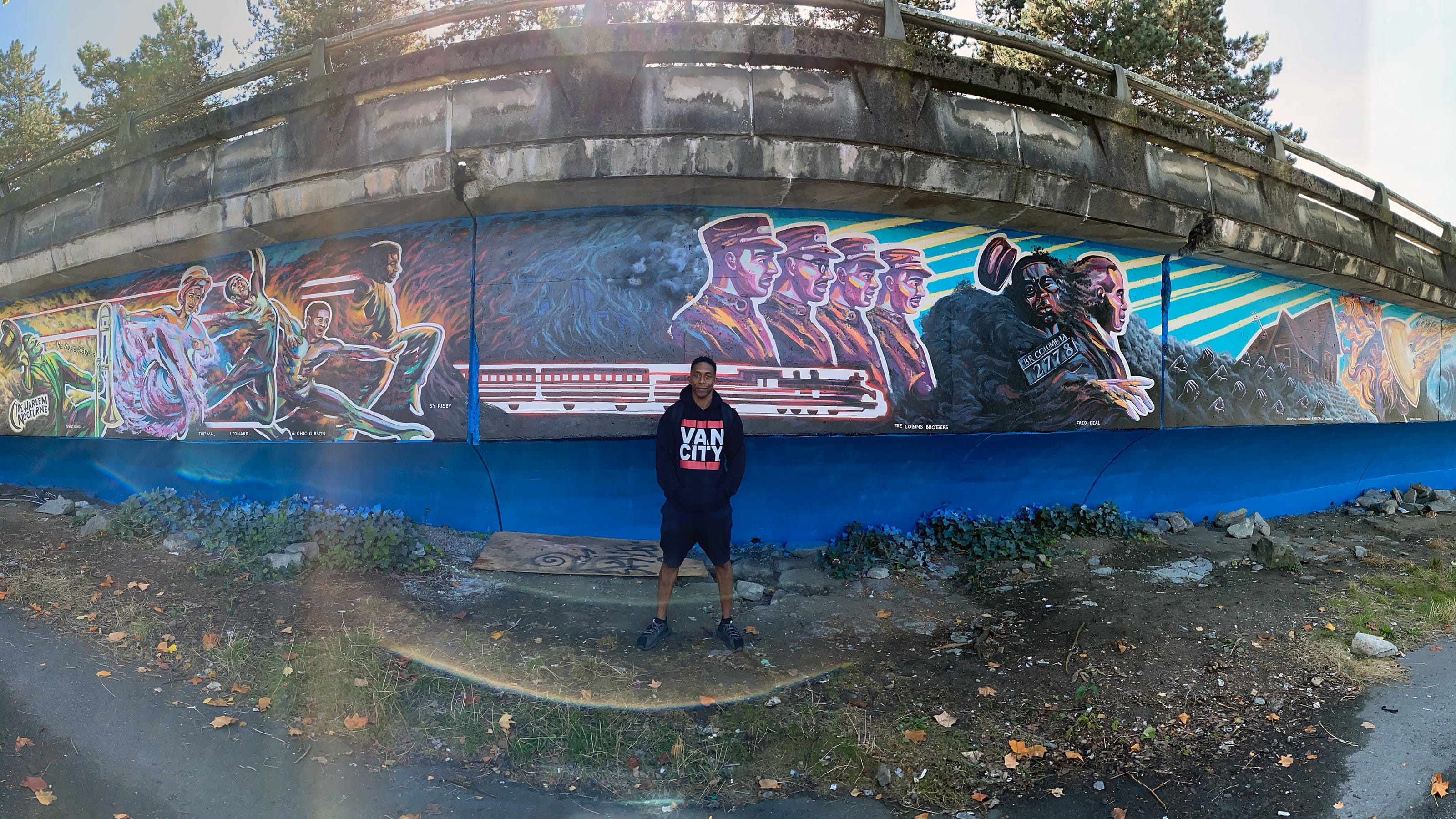 Joseph in front of his mural, 'Hope Through Ashes: A Requiem for Hogan’s Alley' (Rochelle Leung)