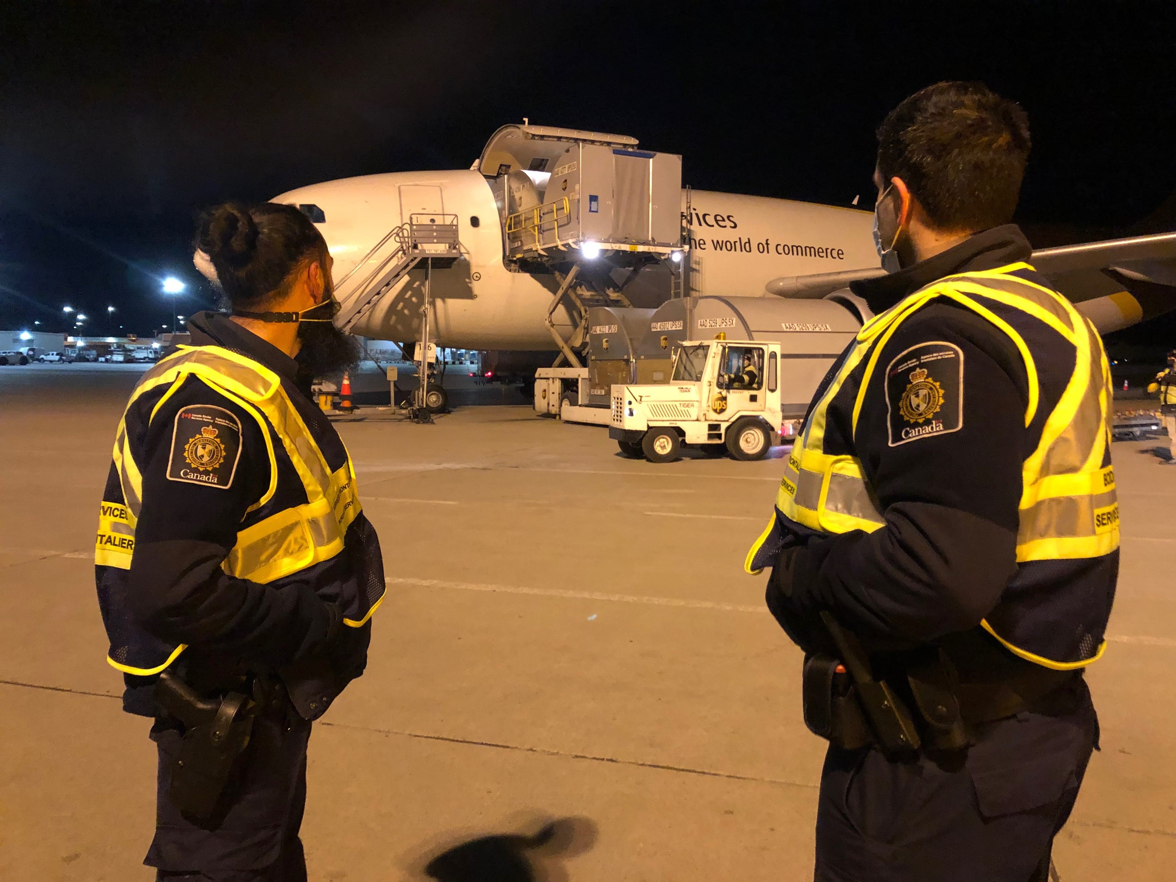 Canada Border Services Agency officials observe as the first doses of Pfizer-BioNTech's COVID-19 vaccine arrive in Quebec on Dec. 13, 2020. (Canada Border Services Agency/Handout)