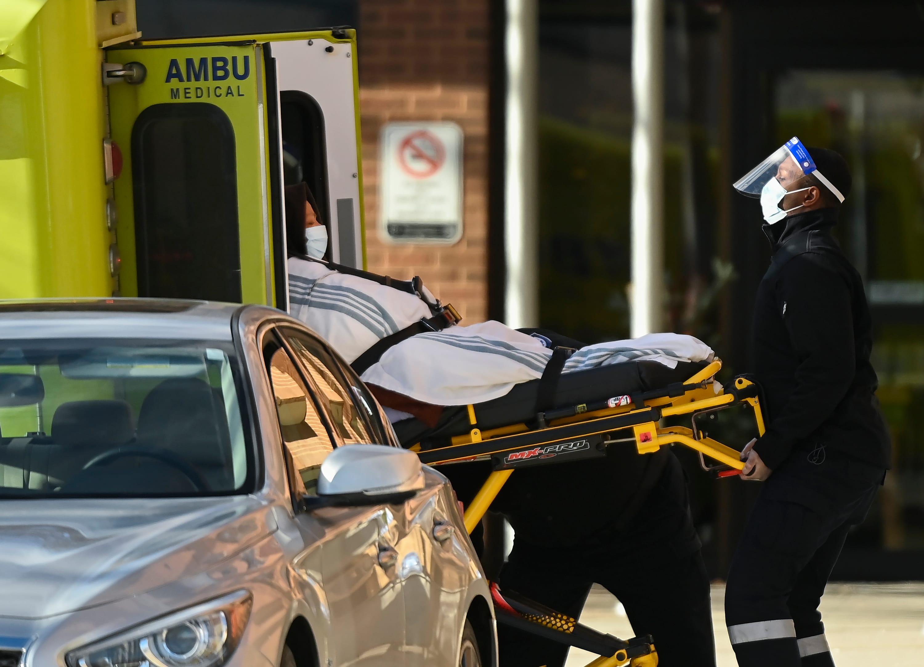 Paramedics take away a person from the Revera Westside Long Term Care Home during the COVID-19 pandemic in Toronto on Dec. 7, 2020 (CP/Nathan Denette)