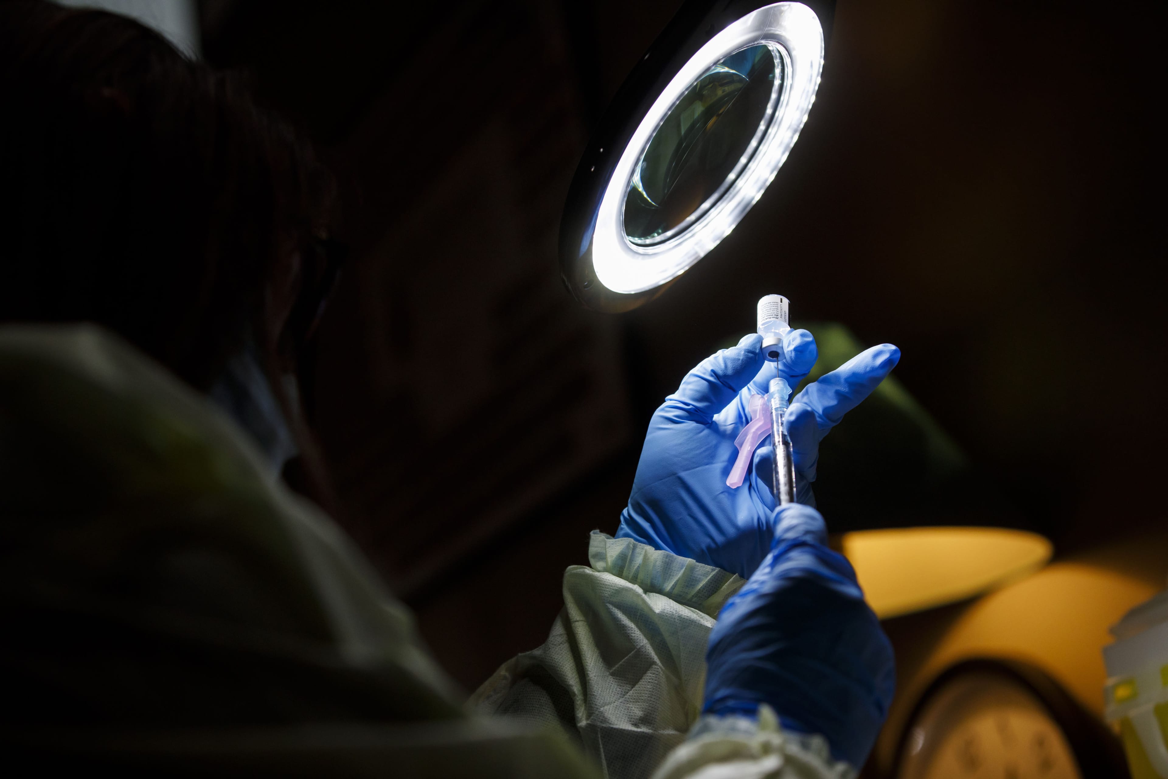 A pharmacy technician prepares a Pfizer-BioNTech Covid-19 vaccine at a University Hospital Network (UHN) vaccination clinic in Toronto, Ontario, Canada, on Tuesday, Dec. 15, 2020. UHN is one of the two sites responsible for piloting the vaccination rollout across Ontario. (Cole Burston/Bloomberg /Getty Images)