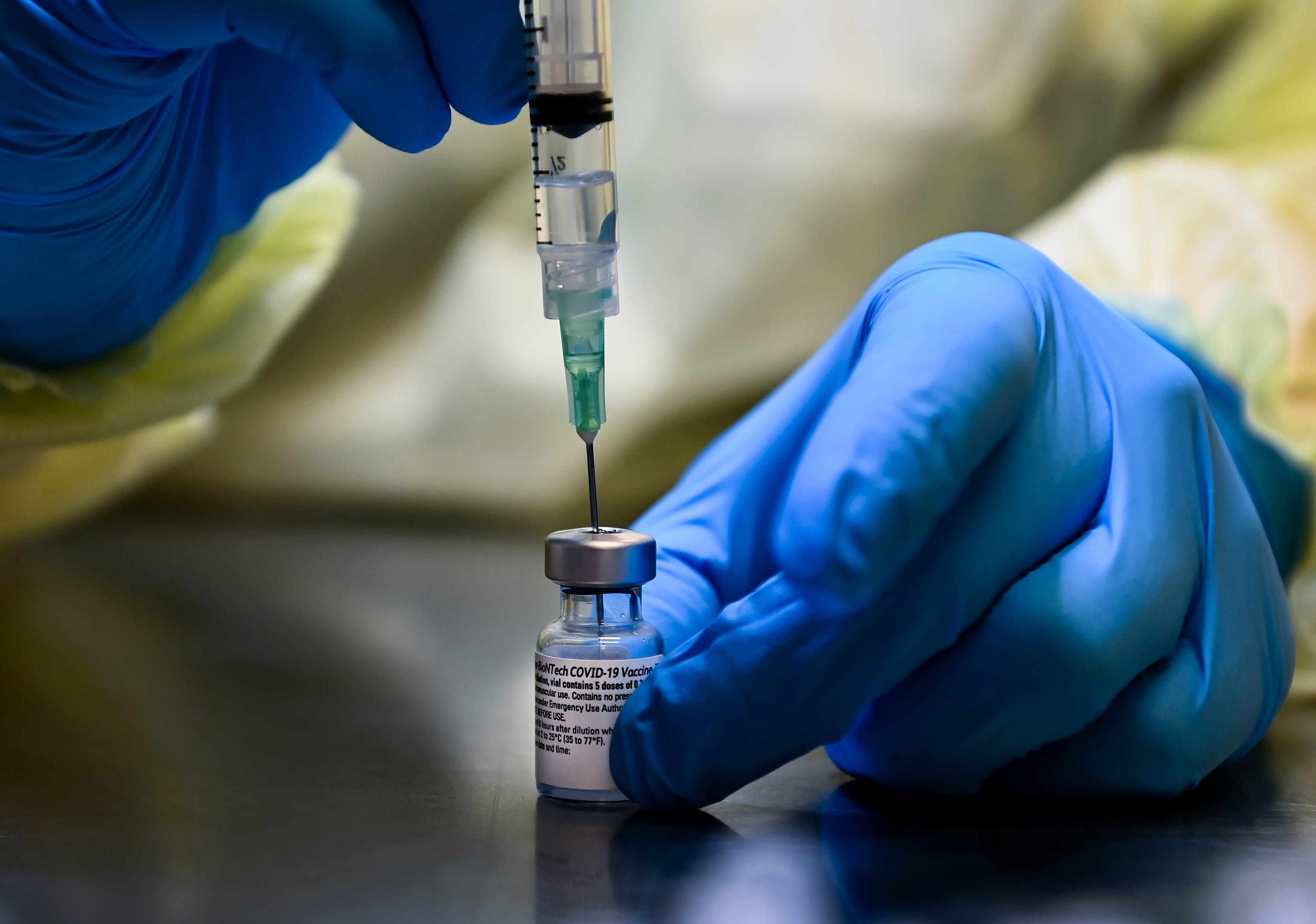 A health-care worker prepares a dose of the Pfizer-BioNTech COVID-19 vaccine at a UHN COVID-19 vaccine clinic in Toronto on Jan. 7, 2021 (CP/Nathan Denette)