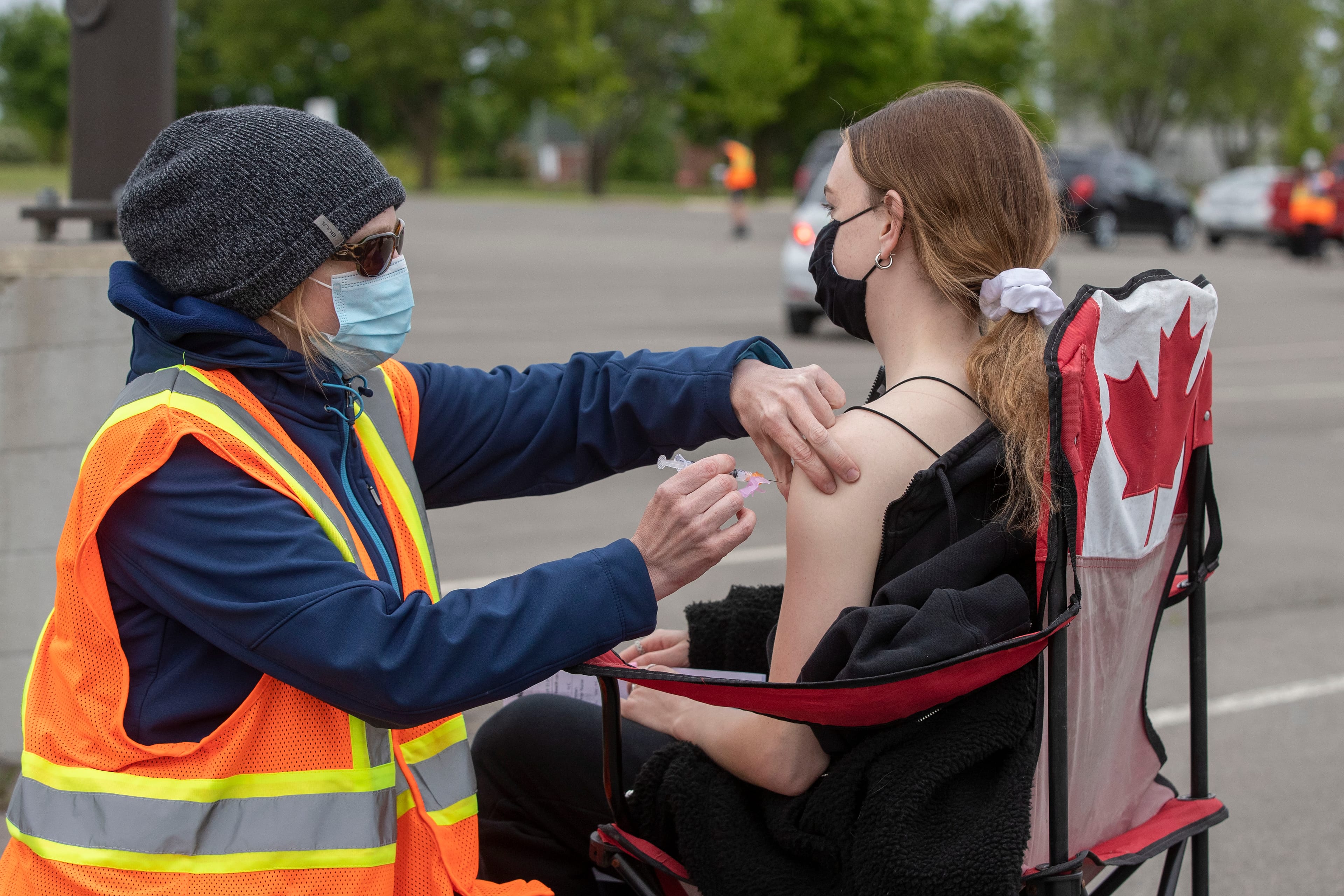 A person receives a COVID-19 vaccine at a drive-thru clinic in Kingston, Ont., on May 28, 2021 (Lars Hagberg/CP)