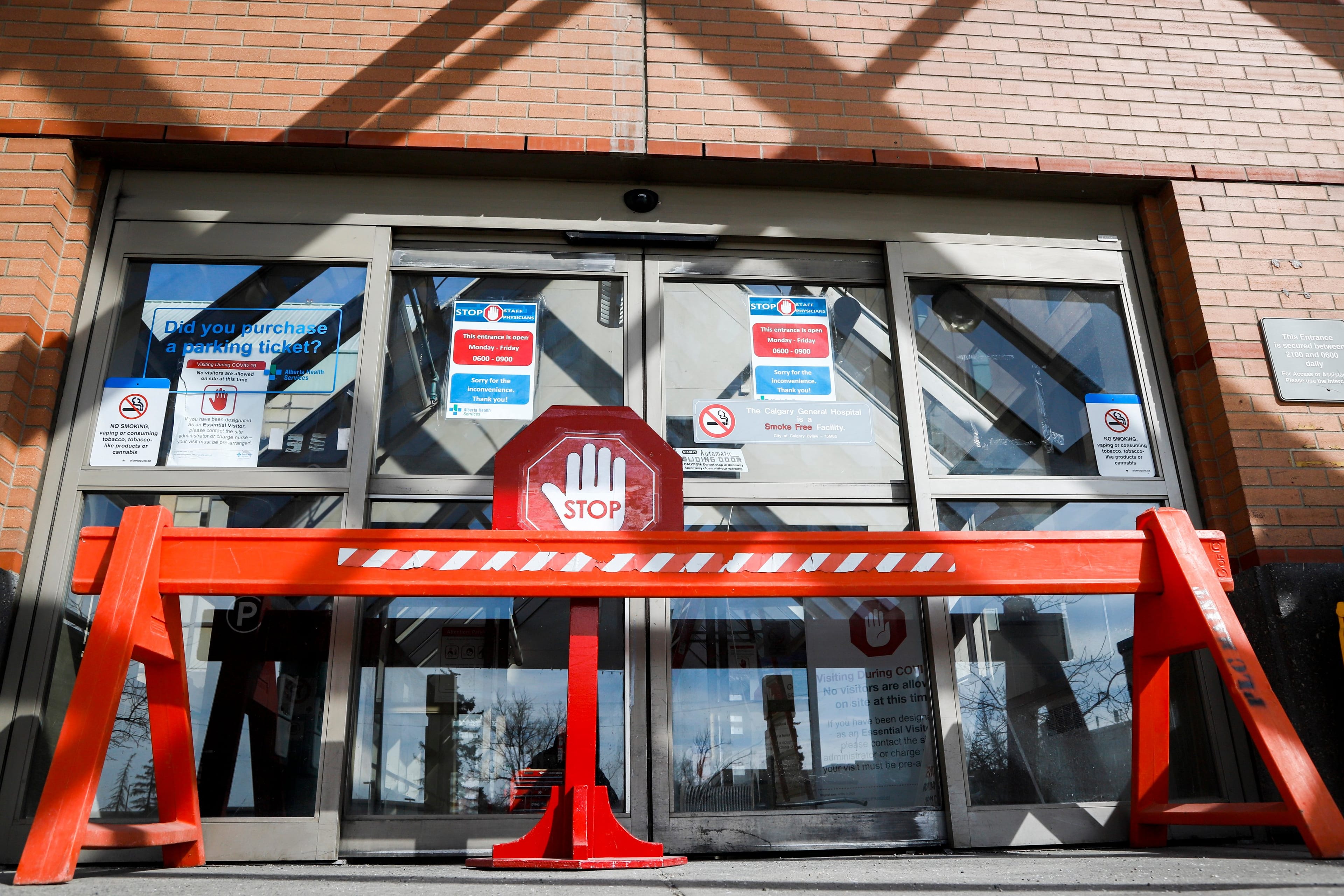 An entrance is blocked to the Peter Lougheed Centre hospital so staff can screen essential visitors who are the only visitors permitted in Alberta hospitals as part of COVID-19 precautions in Calgary, Alta., Thursday, April 9, 2020. THE CANADIAN PRESS/Jeff McIntosh
