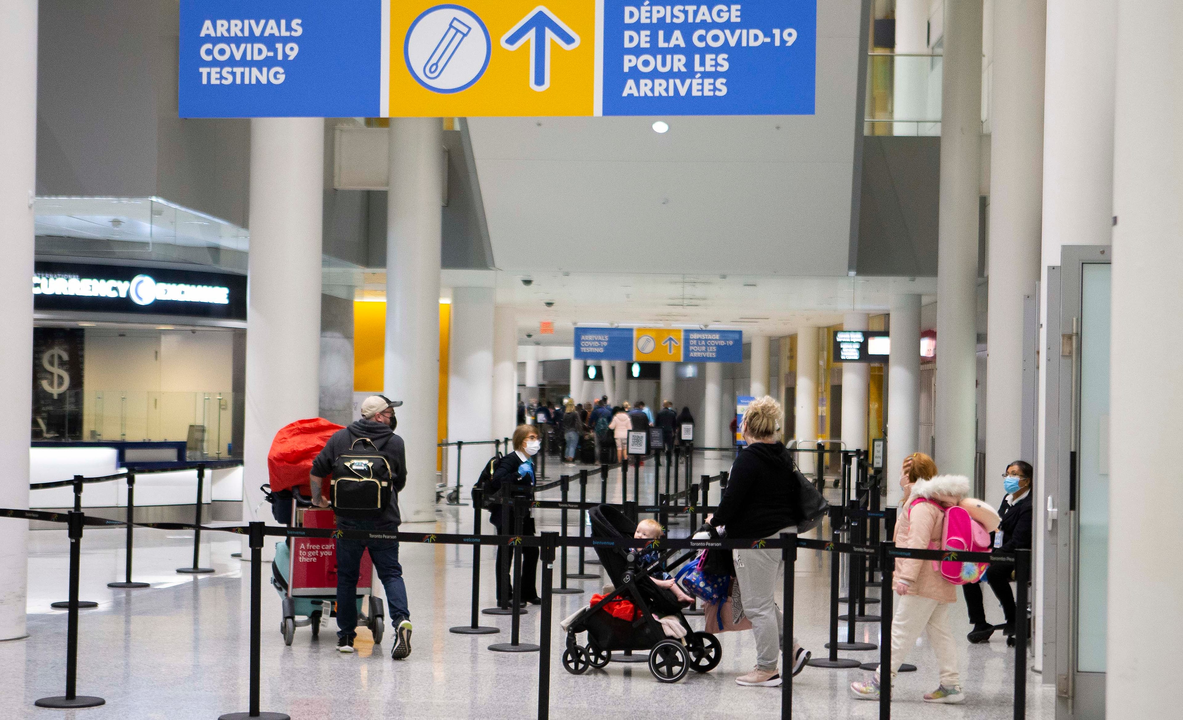 Travellers walk to a COVID-19 testing site after arriving at Toronto Pearson International Airport (Photo courtesy Zou Zheng/Xinhua via ZUMA Press)