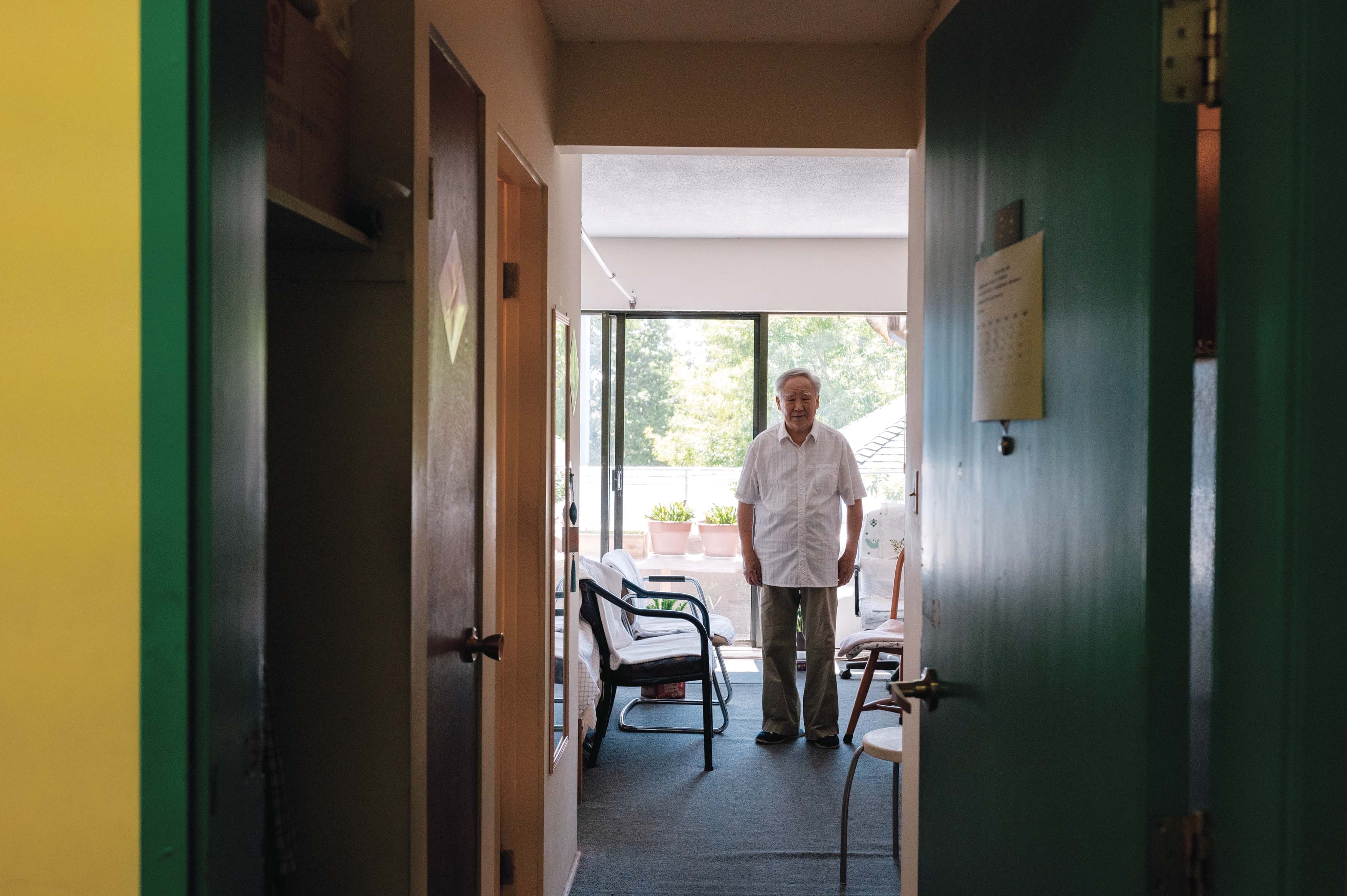Bing Yu Jiao in his Chinatown studio apartment: finding connection in a kind of subdued facsimile of home. (Photograph by Felicia Chang)
