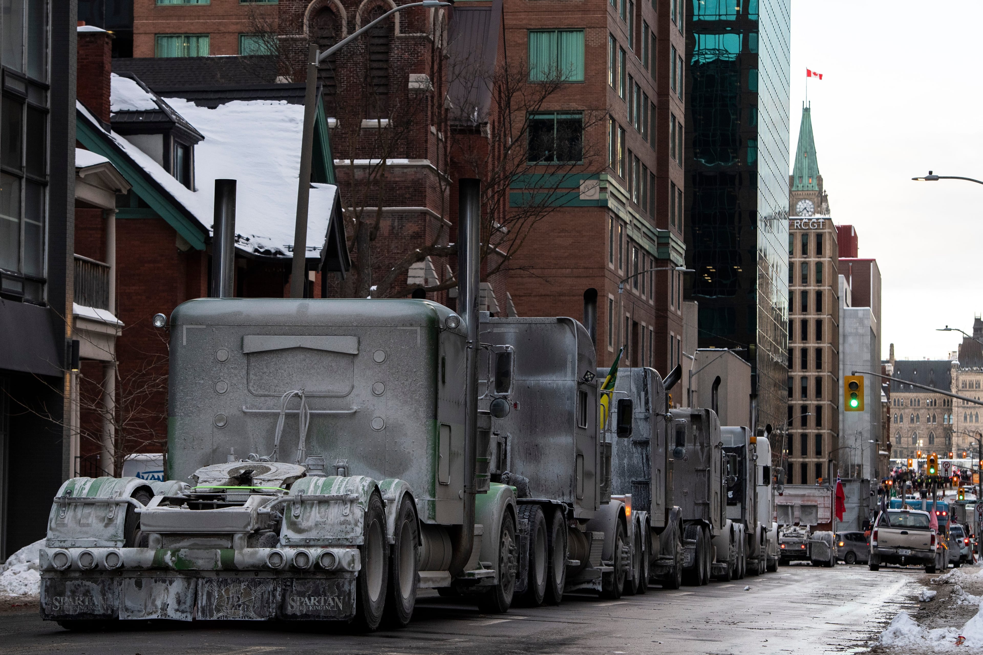 Trucks are parked on Metcalfe Street as a rally against COVID-19 restrictions, Ottawa, Jan. 30, 2022. (Justin Tang/The Canadian Press)