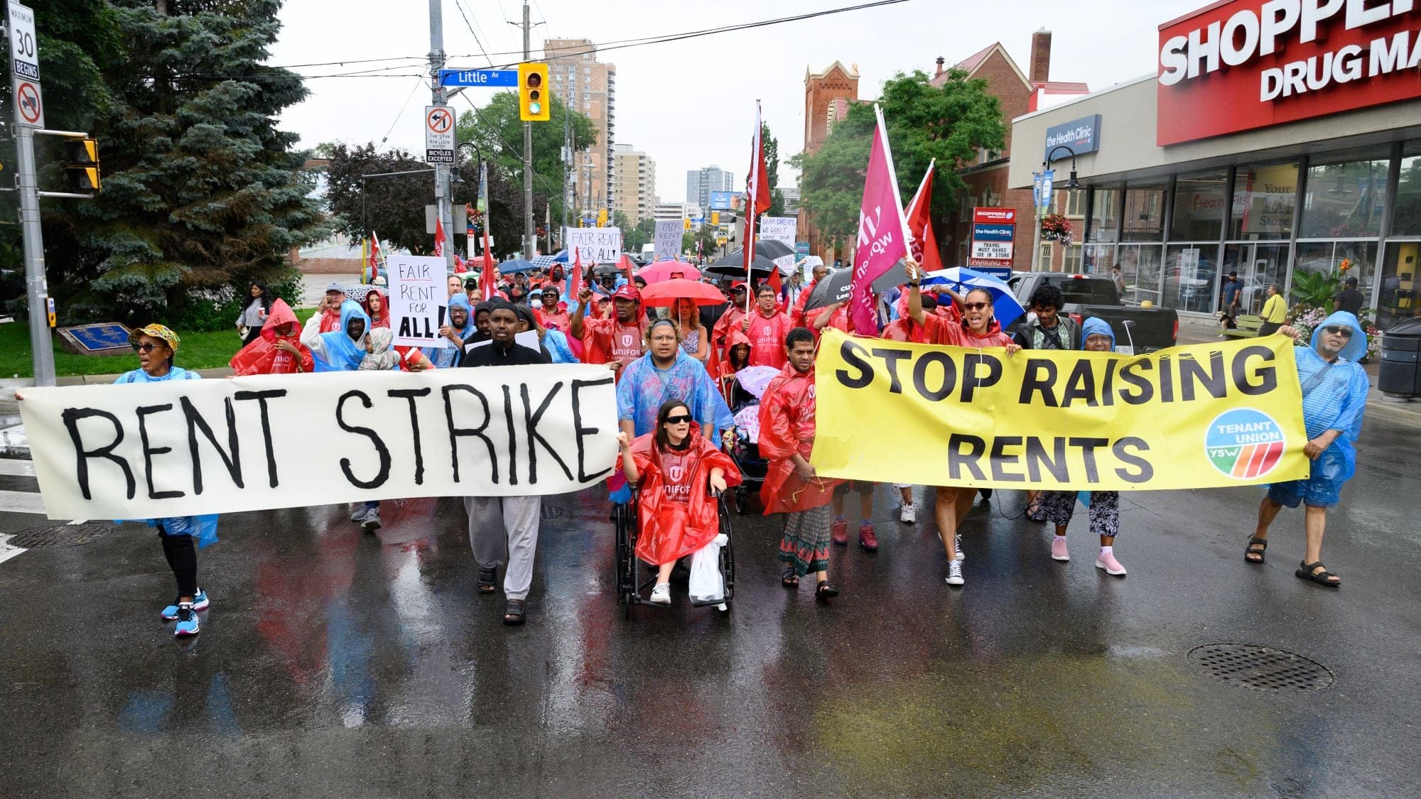 The York South-Weston Tenant Union holding a rally on Weston Road in Toronto, after they decided to withhold rent from their landlord. Hundreds of tenants showed up to the late July rally. (Photograph by Jared Ong) 