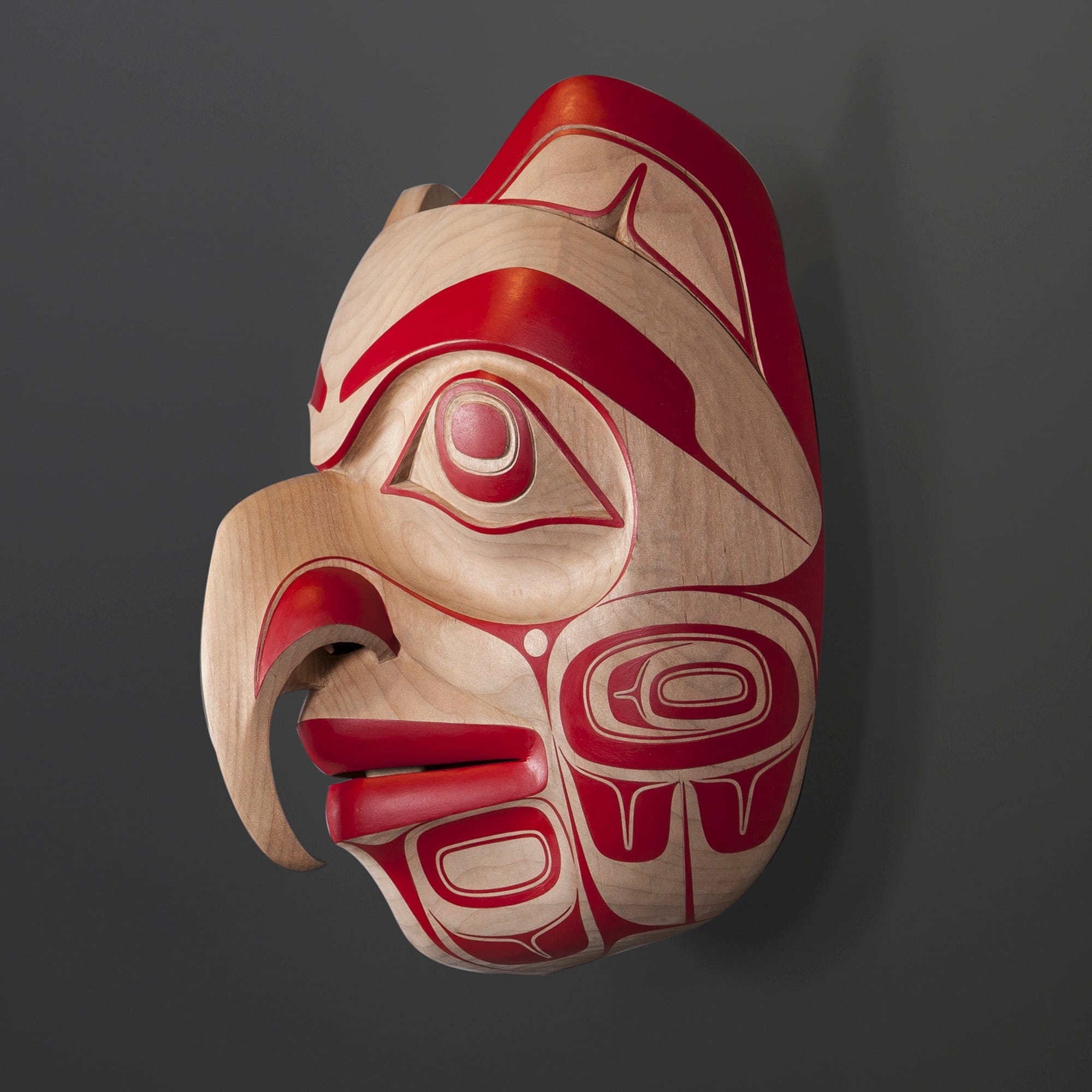 Cori Savard, Becoming Eagle Spirit Claxton: “In Haida Gwaii, you belong either to the Raven or Eagle clan, with the clan lineage passed down through the maternal line. You can sense the Haida Gwaii tradition in this piece, particularly the predominance of red. Often, within the carving world, an artist is mentored by an established carver for many years. Savard learned carving techniques through two multi-year apprenticeships with Haida artists Reg Davidson and Ben Davidson.”