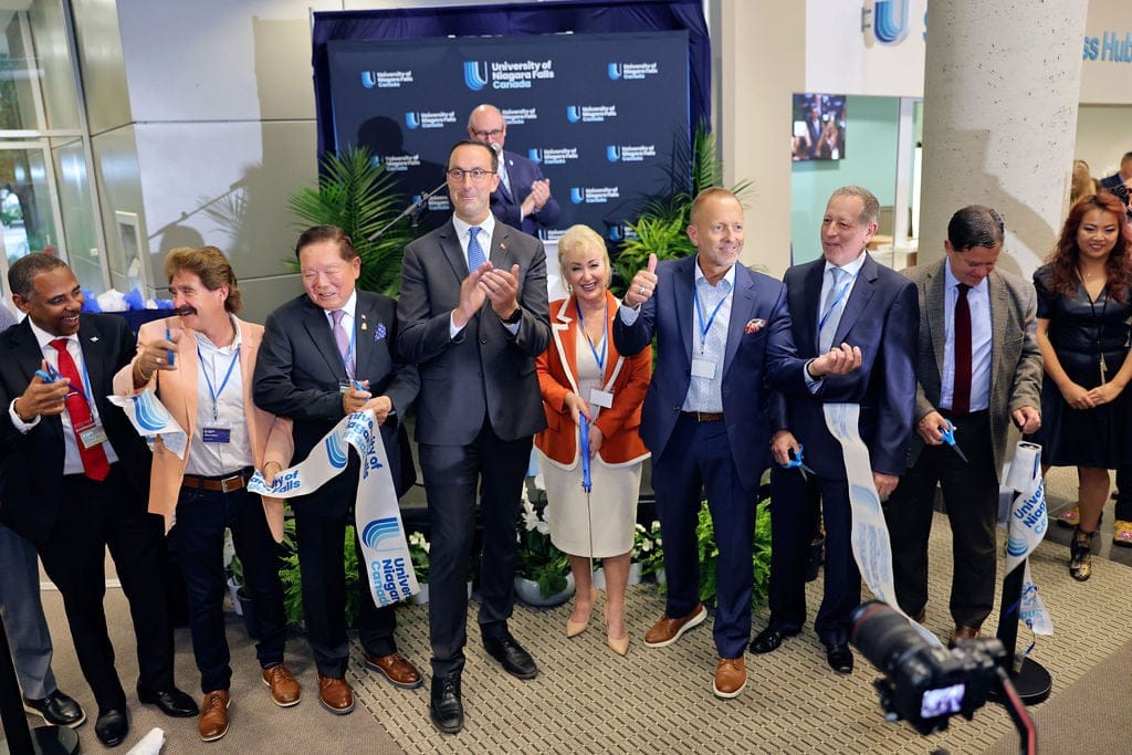 Cutting the ribbon at University of Niagara Falls, from left to right: Henry Mangal, Consul General of St. Lucia in Toronto; Niagara Falls MPP Wayne Gates; former Senator Victor Oh; Ontario Minister of Colleges and Universities Nolan Quinn; UNF VP Academic David Gray; GUS Canada CEO Cyndi McLeod; Niagara Falls Mayor Jim Diodati; GUS Canada Board Chair Gary Narunsky; Porfirio Thierry Muñoz Ledo, Consul General of Mexico in Toronto; and GUS Canada Executive Affairs Coordinator Michelle Huang.