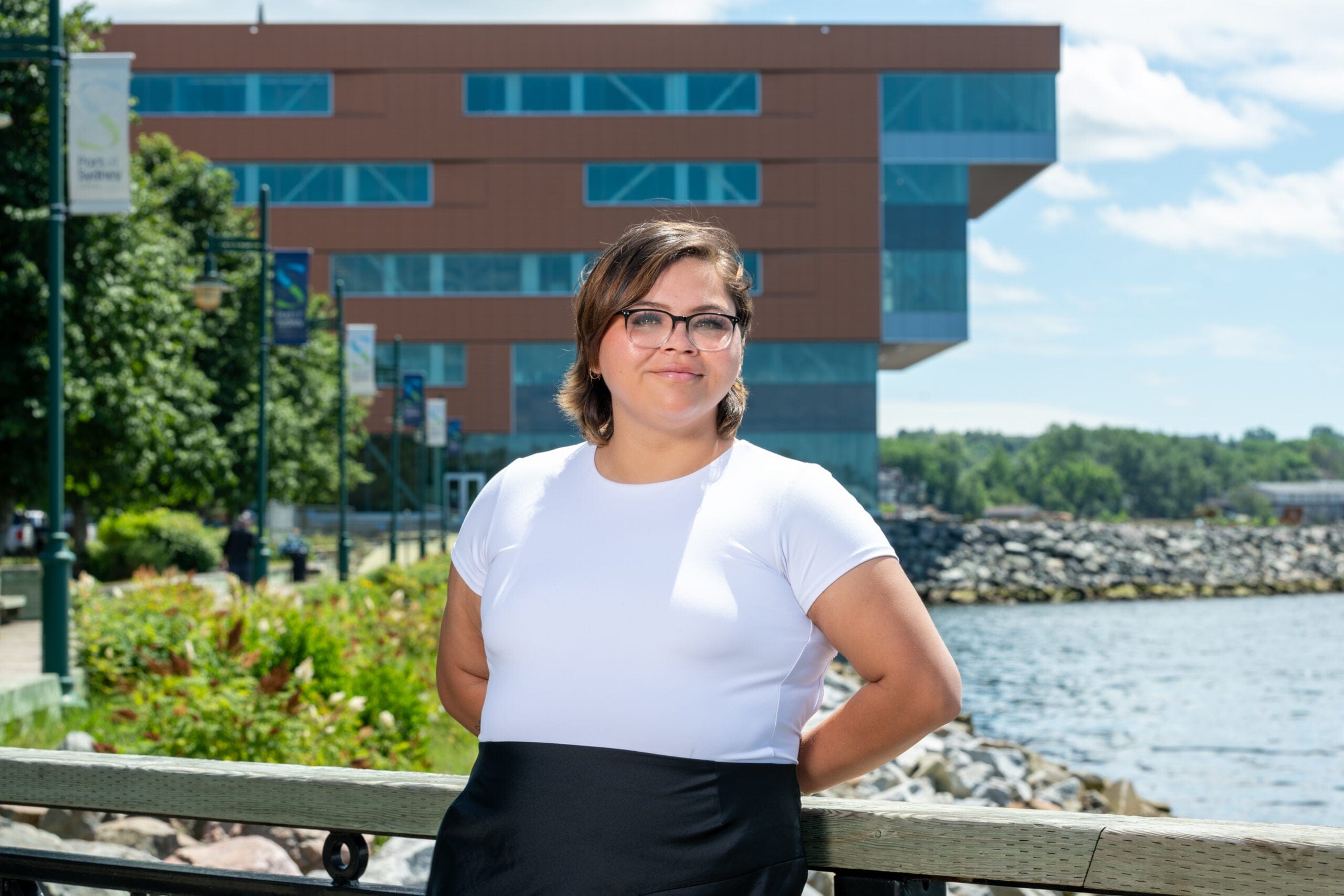 photo of college student in front of campus building