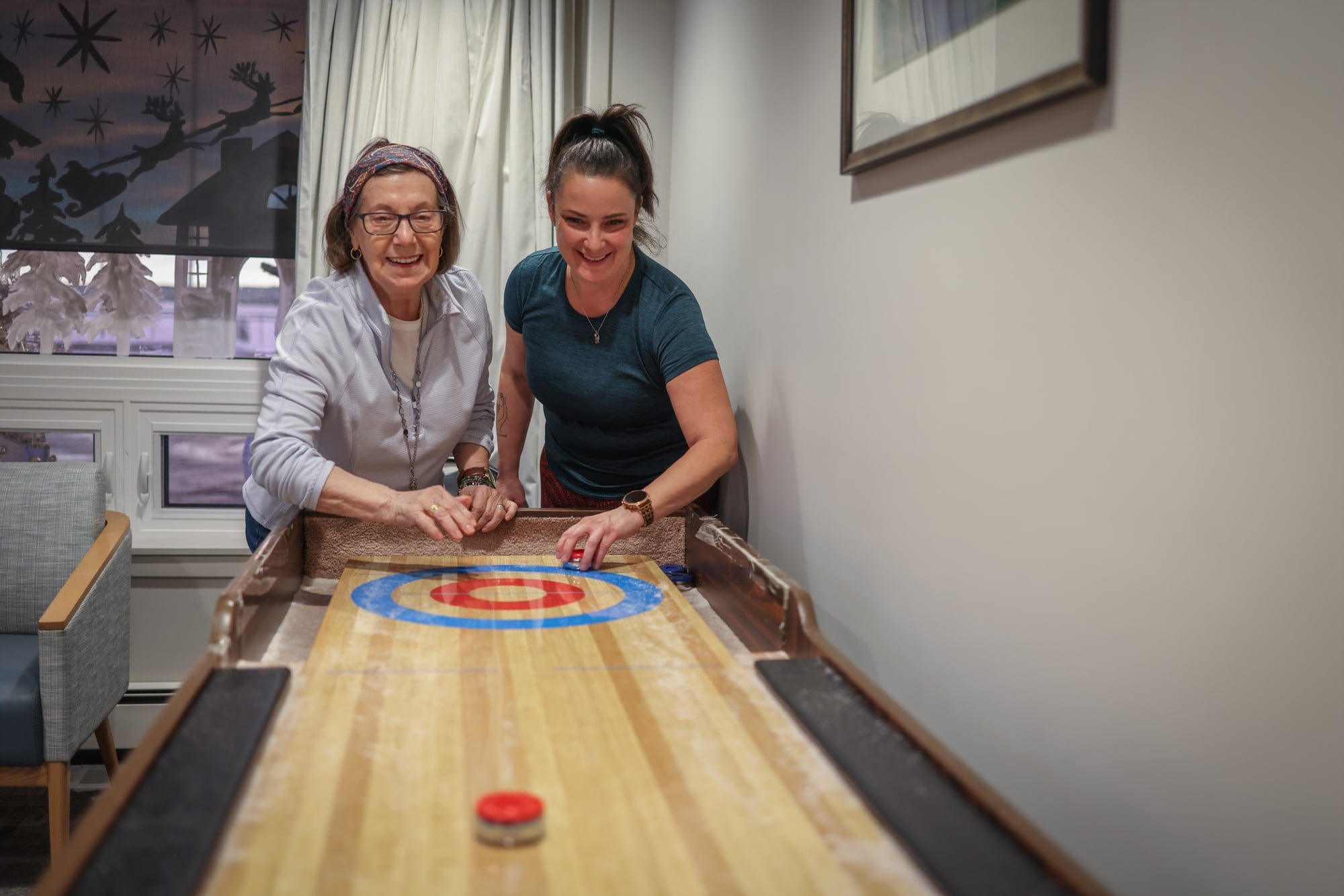 A student plays a game with a senior