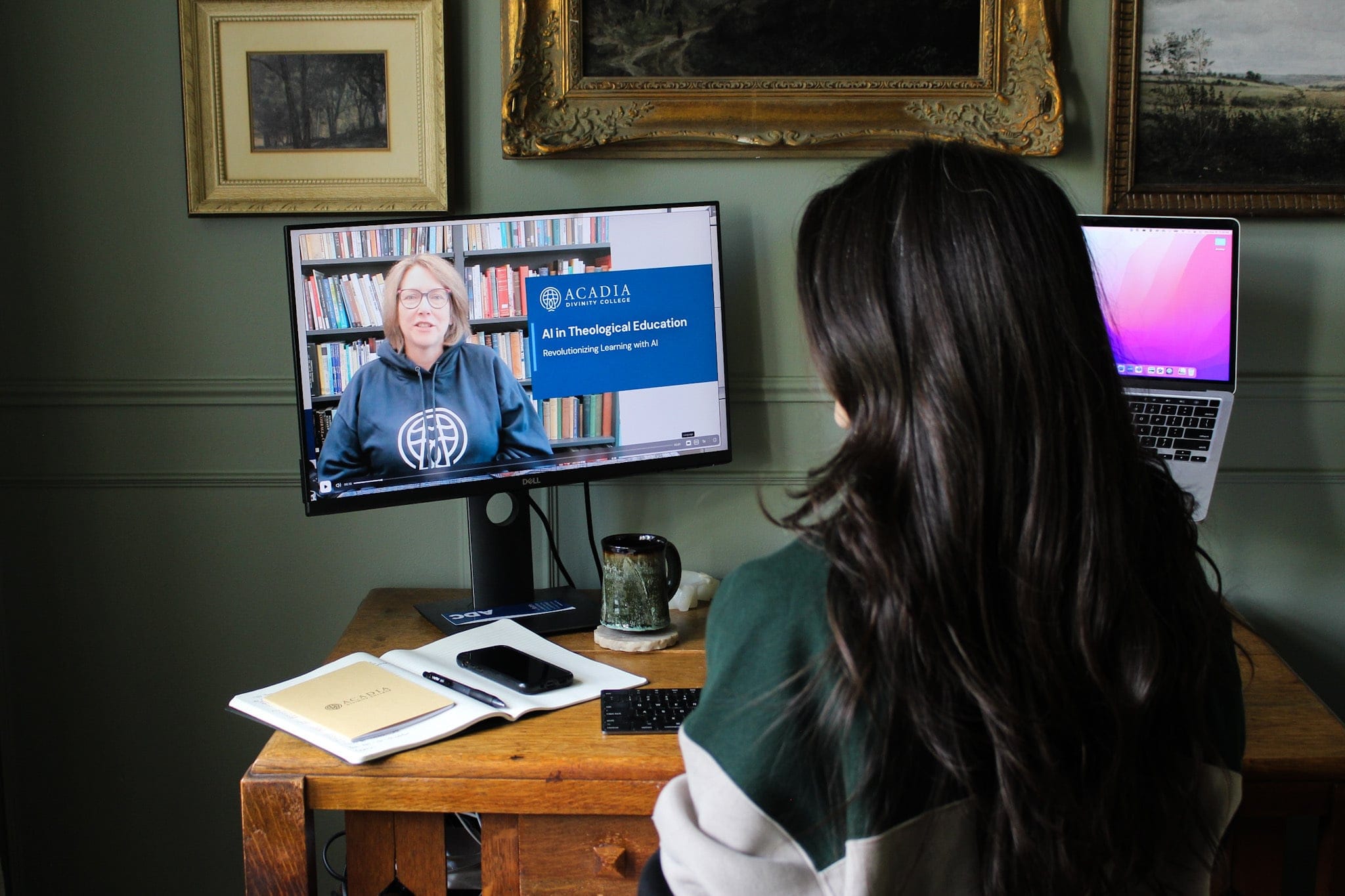A young woman sitting at a desk and watching a lecture video about AI in Theological Education