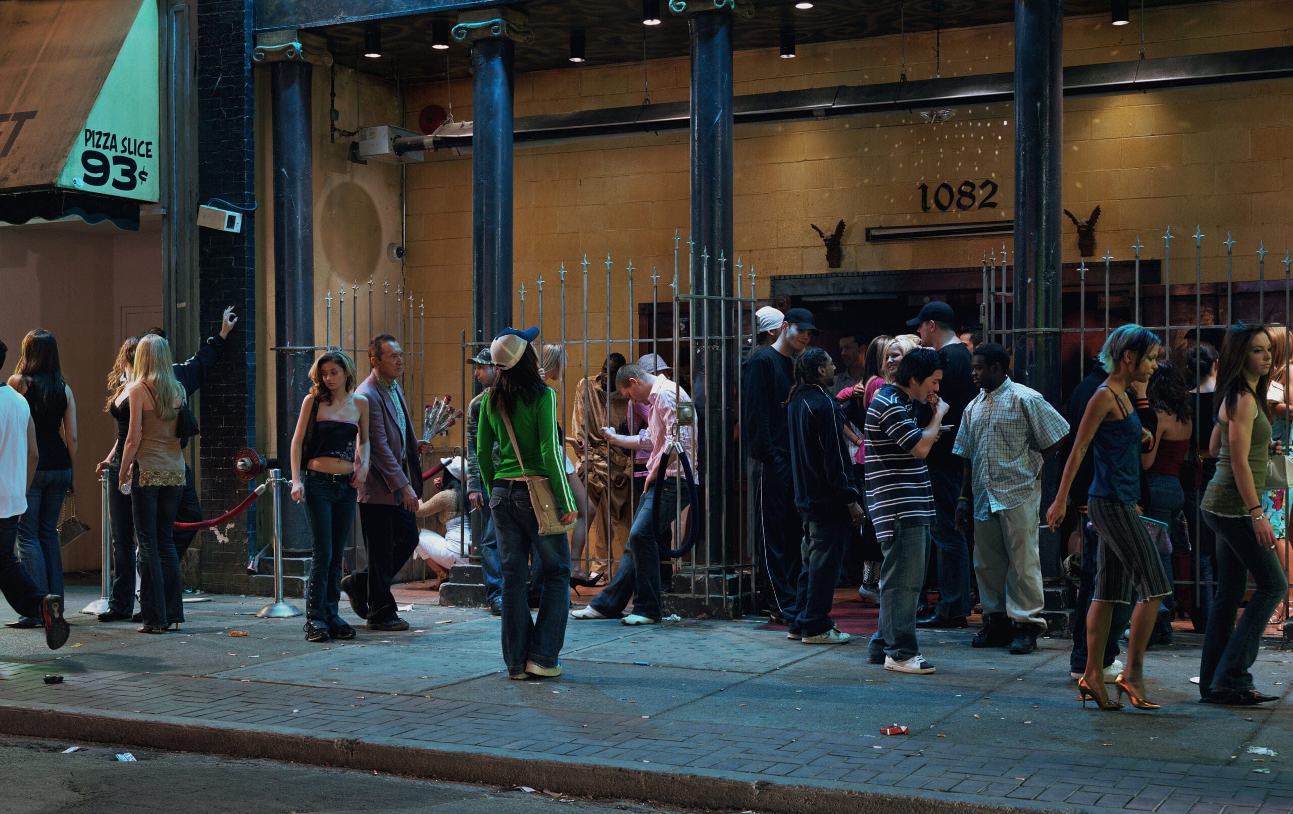 Many people waiting along the entrance of a nightclub