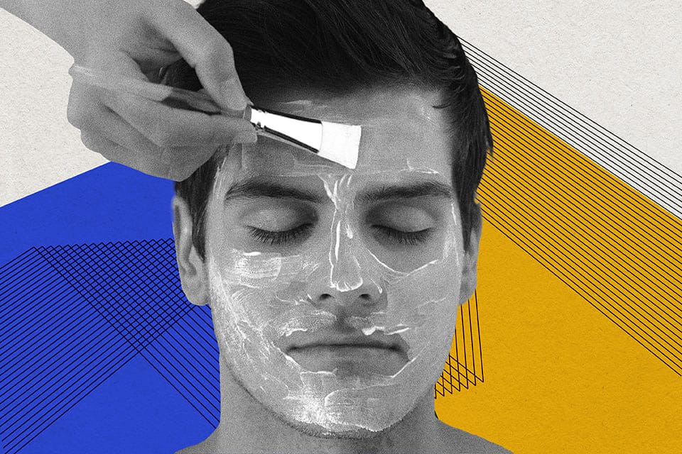 A man lying down with his eyes closed. A hand is applying jelly to his face.