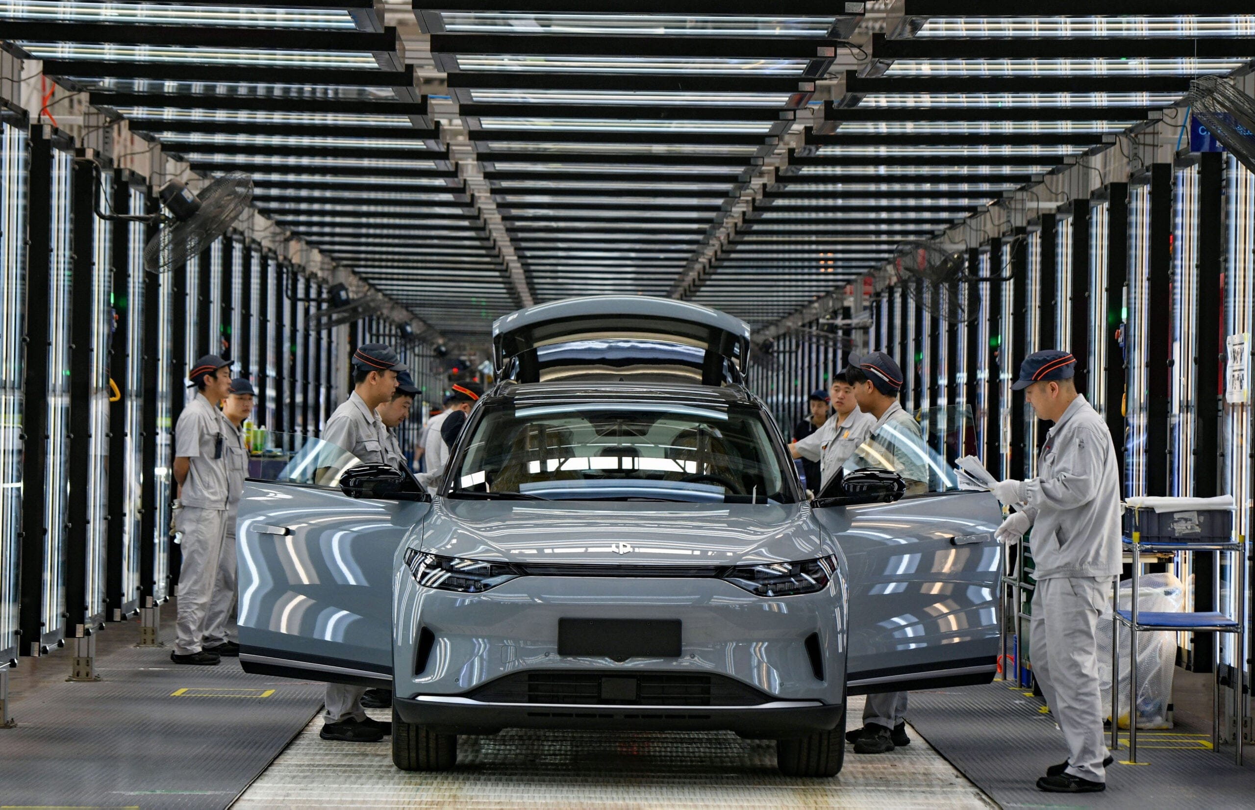 A dark grey car in a factory