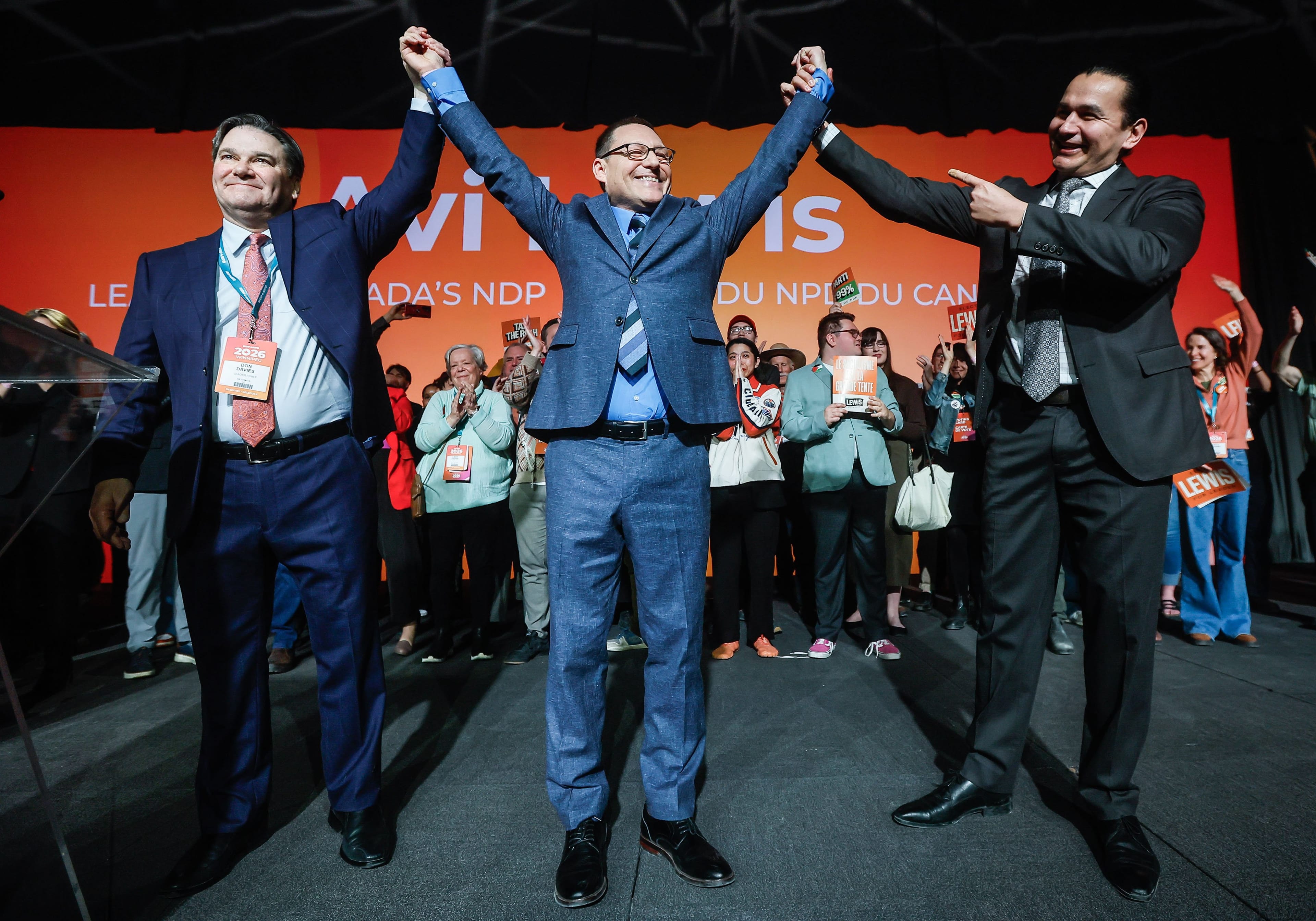 Avi Lewis, centre, who was proclaimed as the new leader of the NDP, celebrates with former interim leader Don Davies, left, and Manitoba premier Wab Kinew at the party convention in Winnipeg Sunday, March 29, 2026. THE CANADIAN PRESS/John Woods