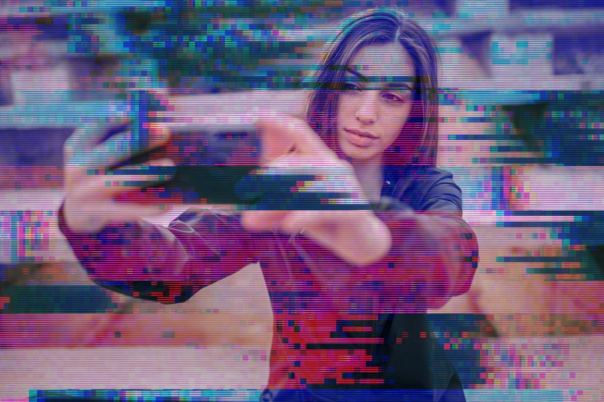 A girl sitting taking a selfie on her phone with both arms out, with a purple and green graphic over top distorting her.
