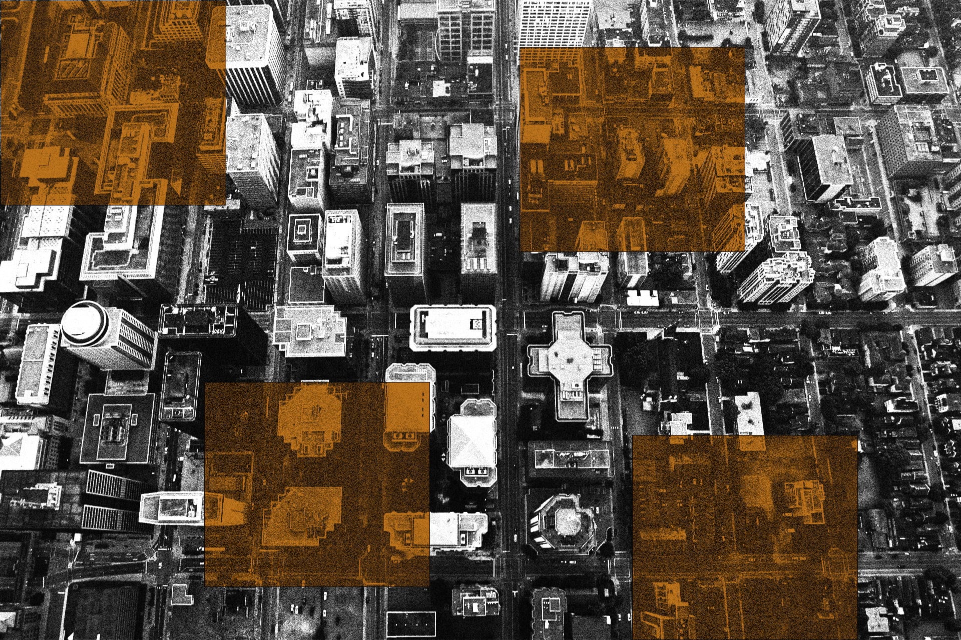 Black and white aerial shot of tall city buildings, with rusty orange squares overtop.