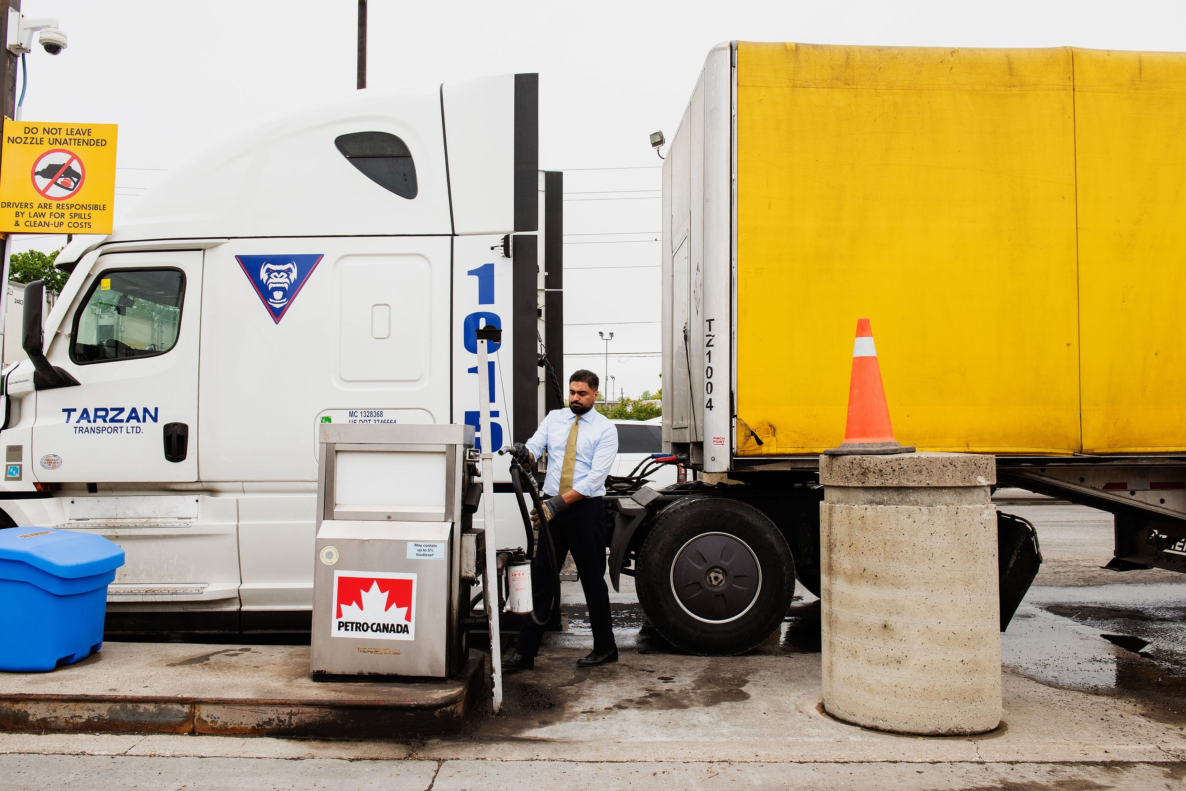 A man standing in front of a large truck