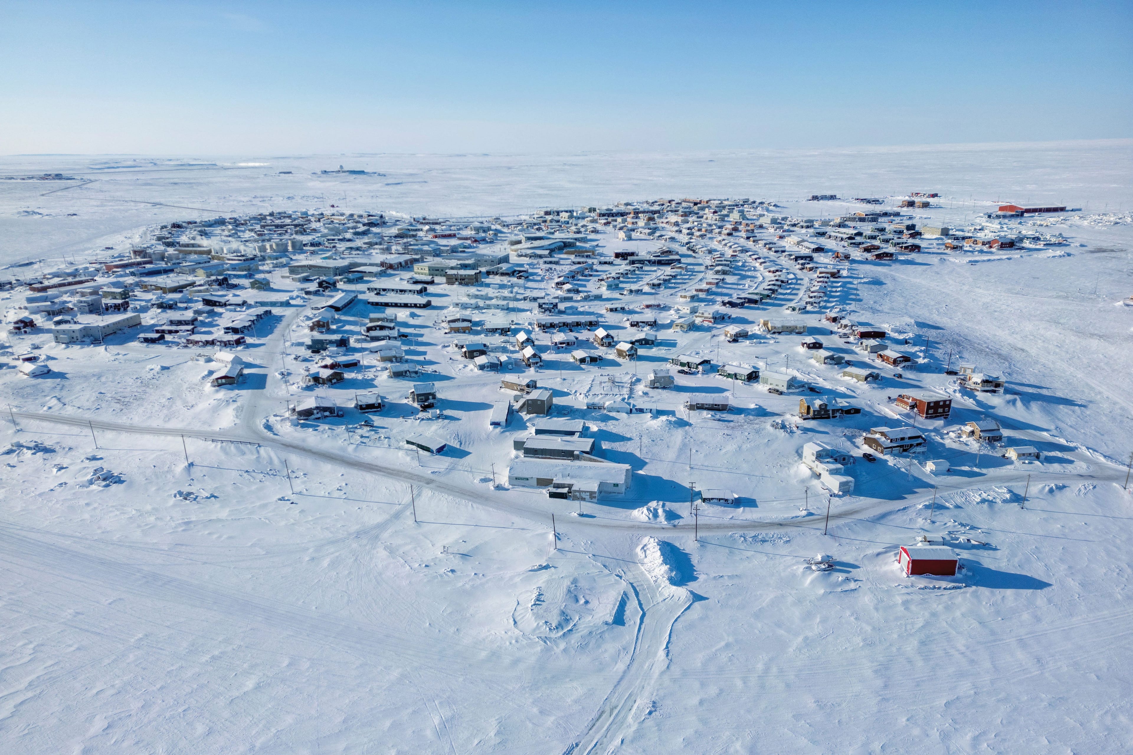 A snowy landscape dotted with little houses