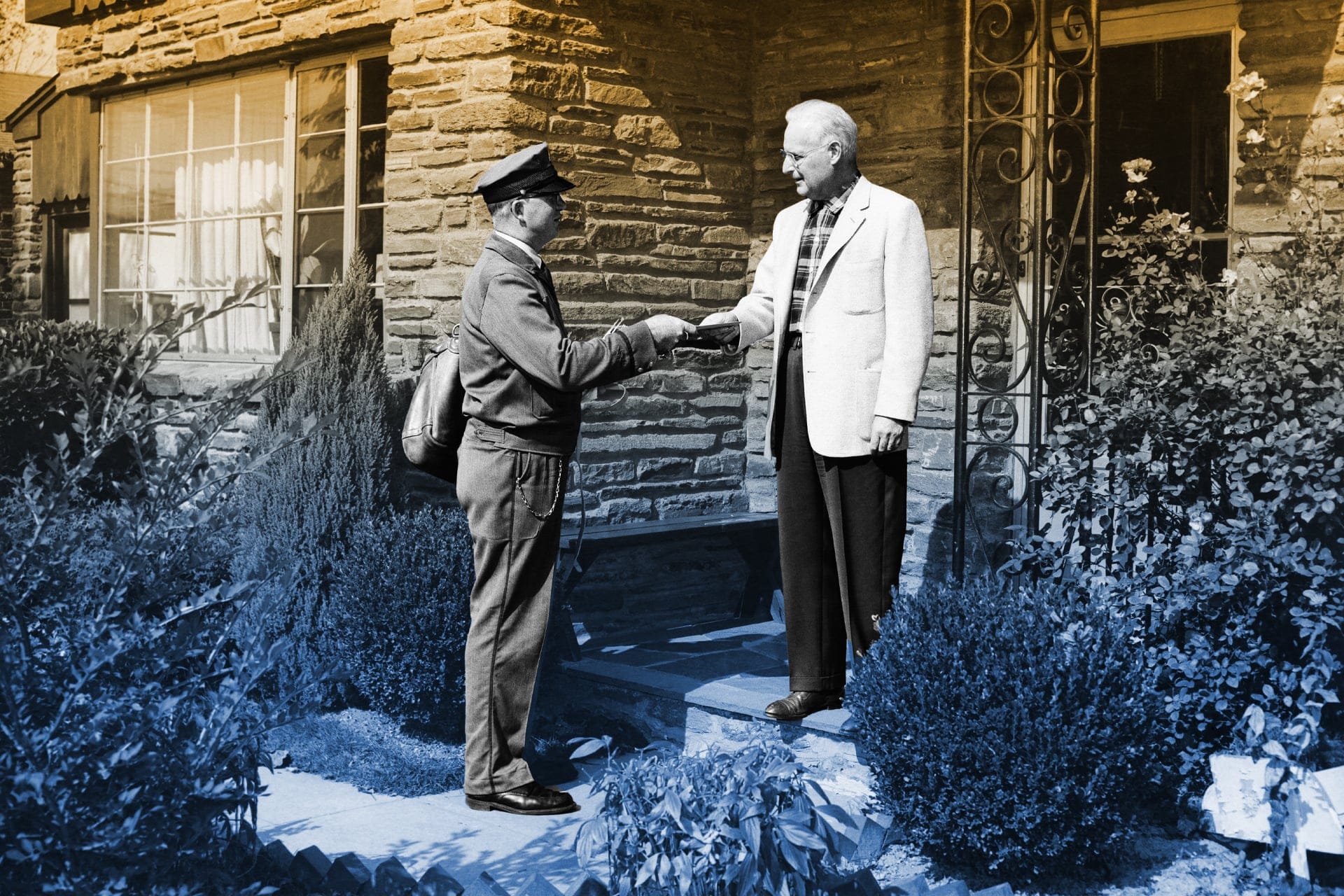 A postal worker greets an older man at this doorstep
