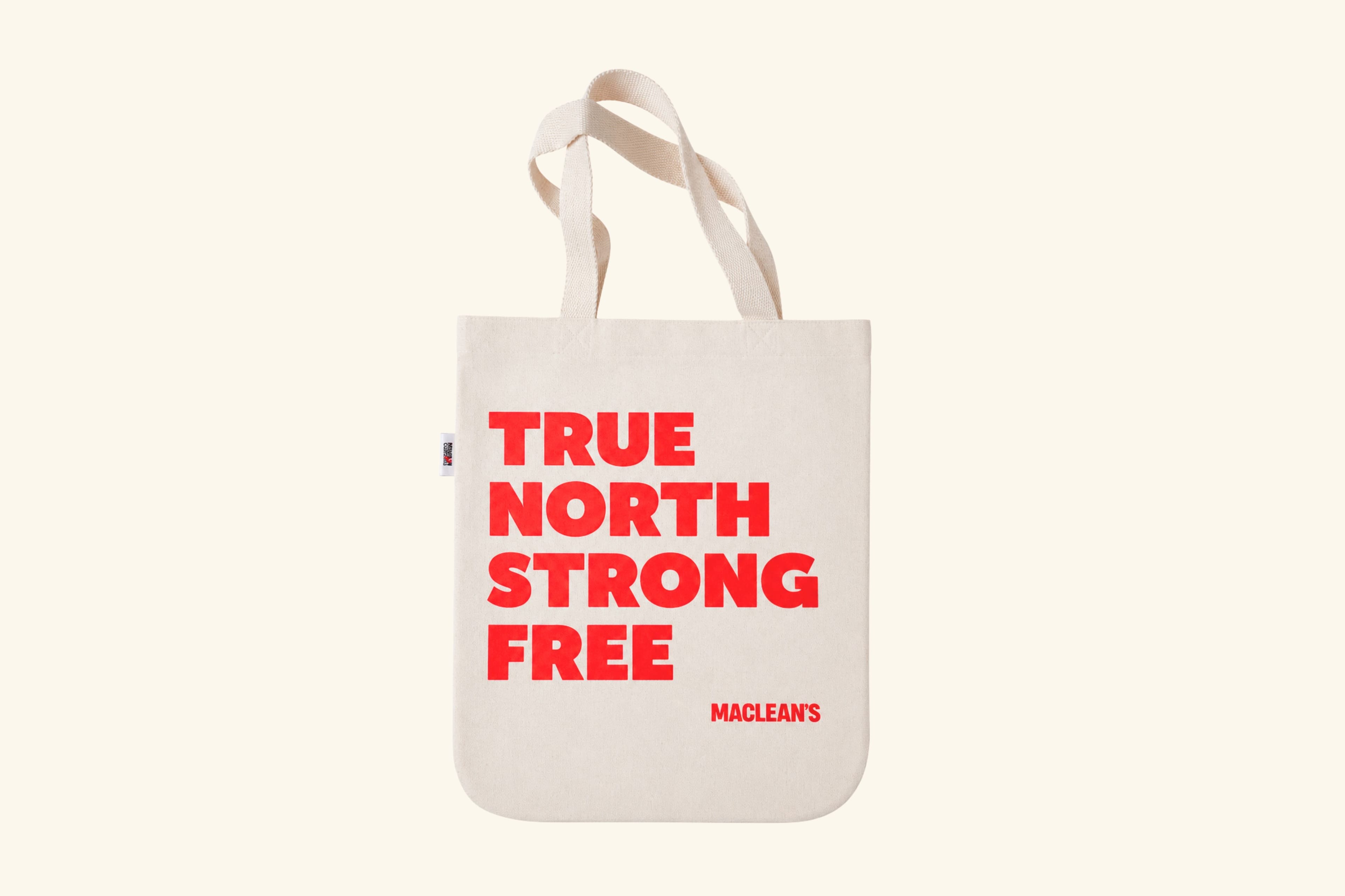 A tote bag that says TRUE NORTH STRONG FREE in red lettering